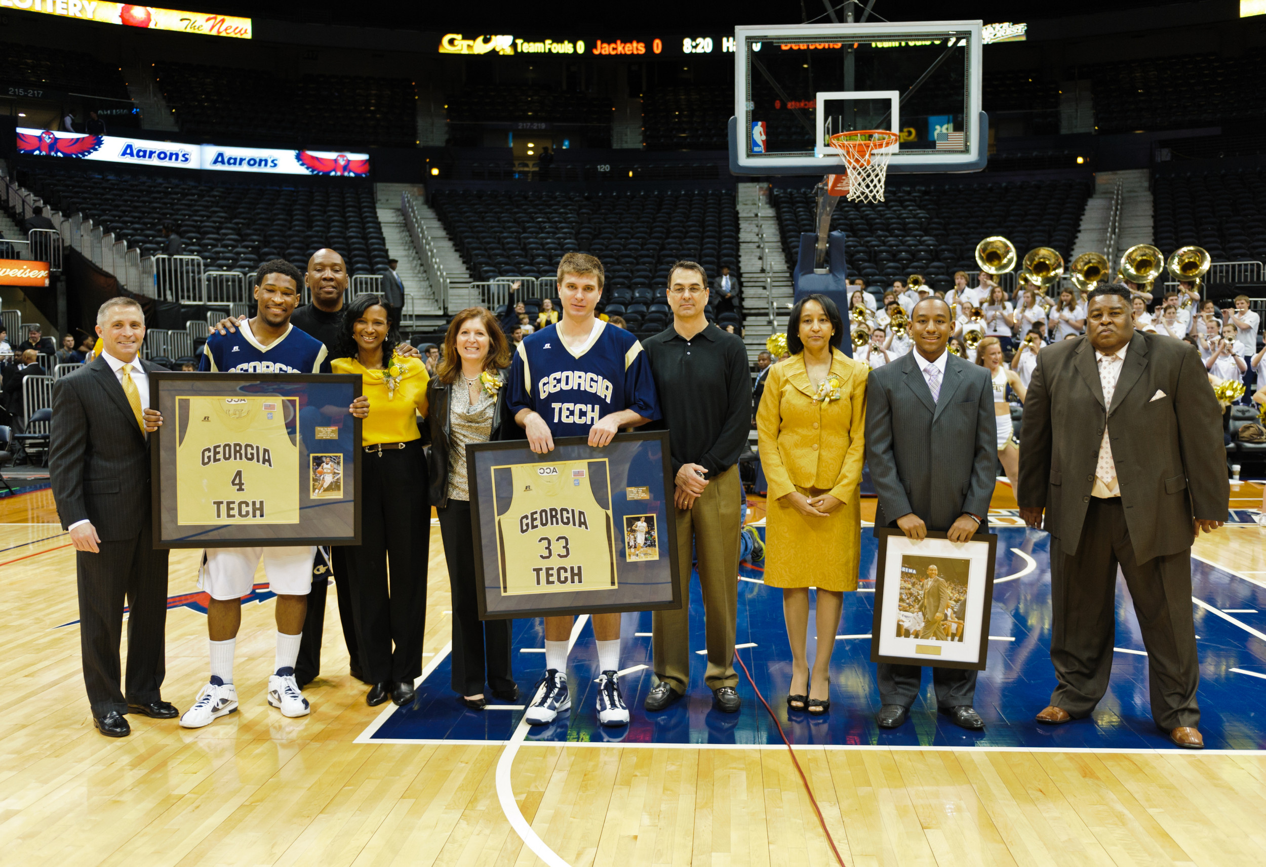Marcus Fondon, Derek Craig (33), Nick Foreman (4), and their parents pose with Coach Gregory after the Senior Day ceremony.