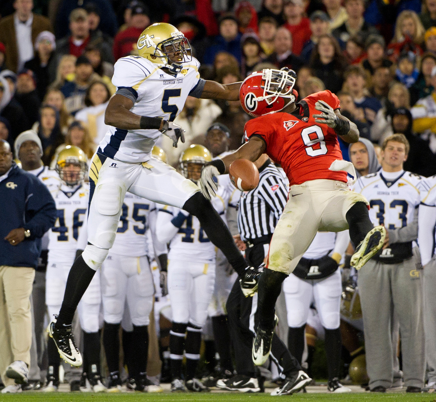 Georgia Tech wide receiver Stephen Hill (5) and Georgia safety Alec Ogletree (9) compete for a pass. (AP Photo/Rich Addicks)