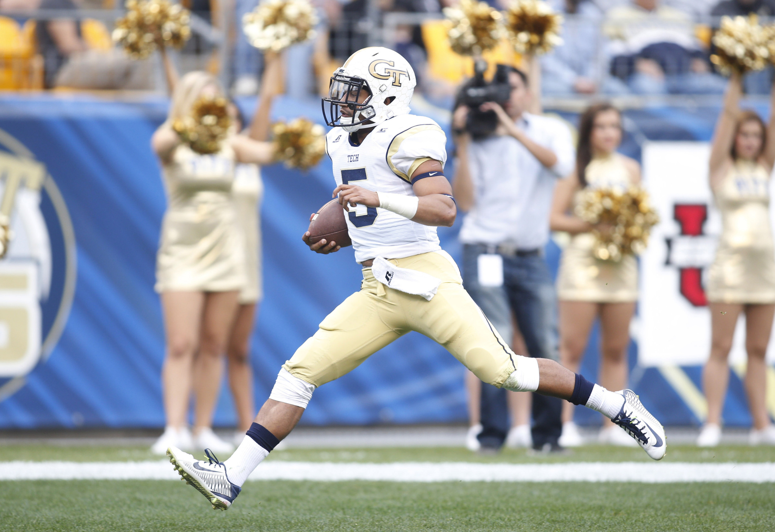 Oct 25, 2014; Pittsburgh, PA, USA; Yellow Jackets quarterback Justin Thomas (5) scores on a thirteen yard touchdown run during the first quarter. Charles LeClaire-USA TODAY Sports