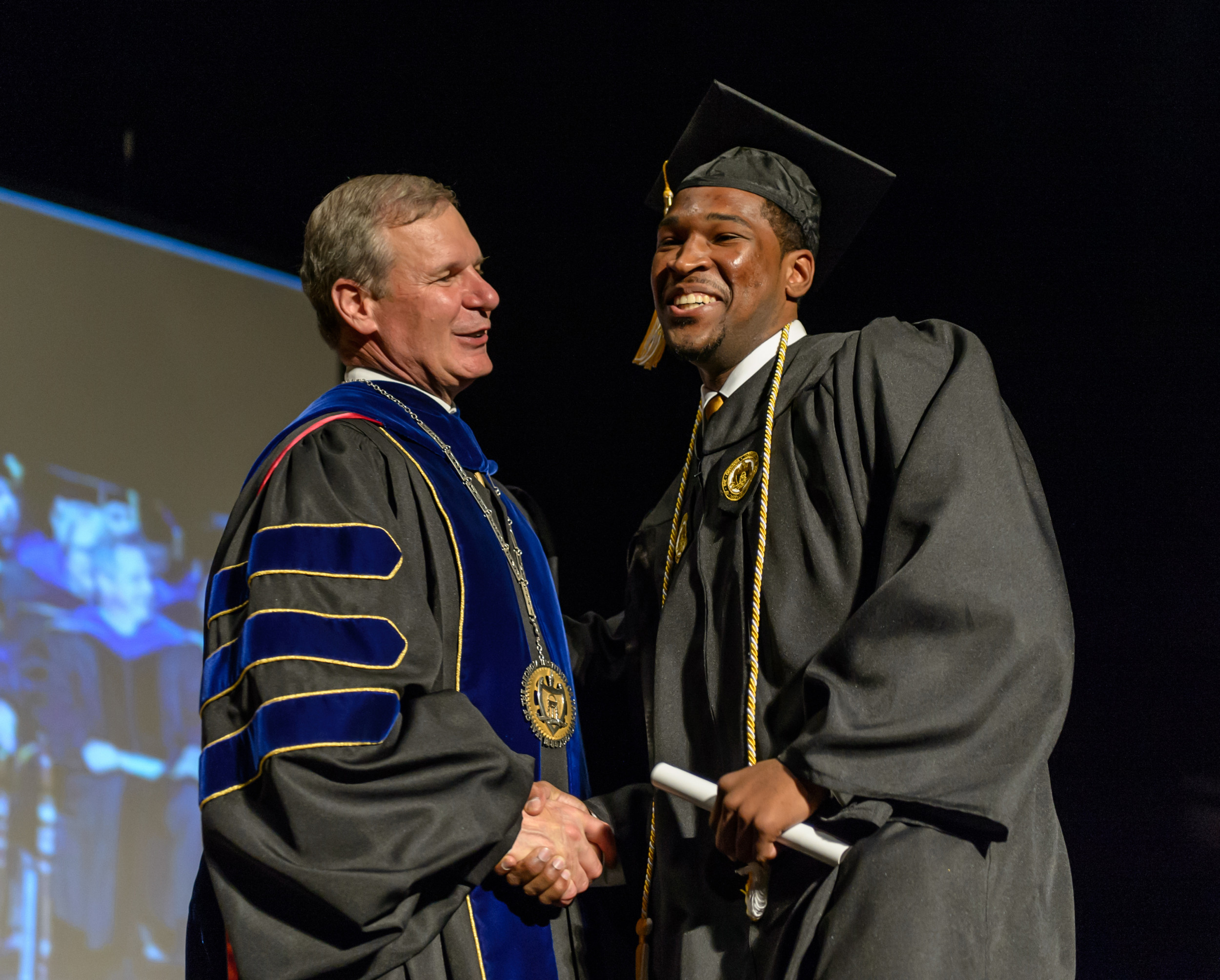 Nick Foreman is greeted by Tech president Dr. Bud Peterson