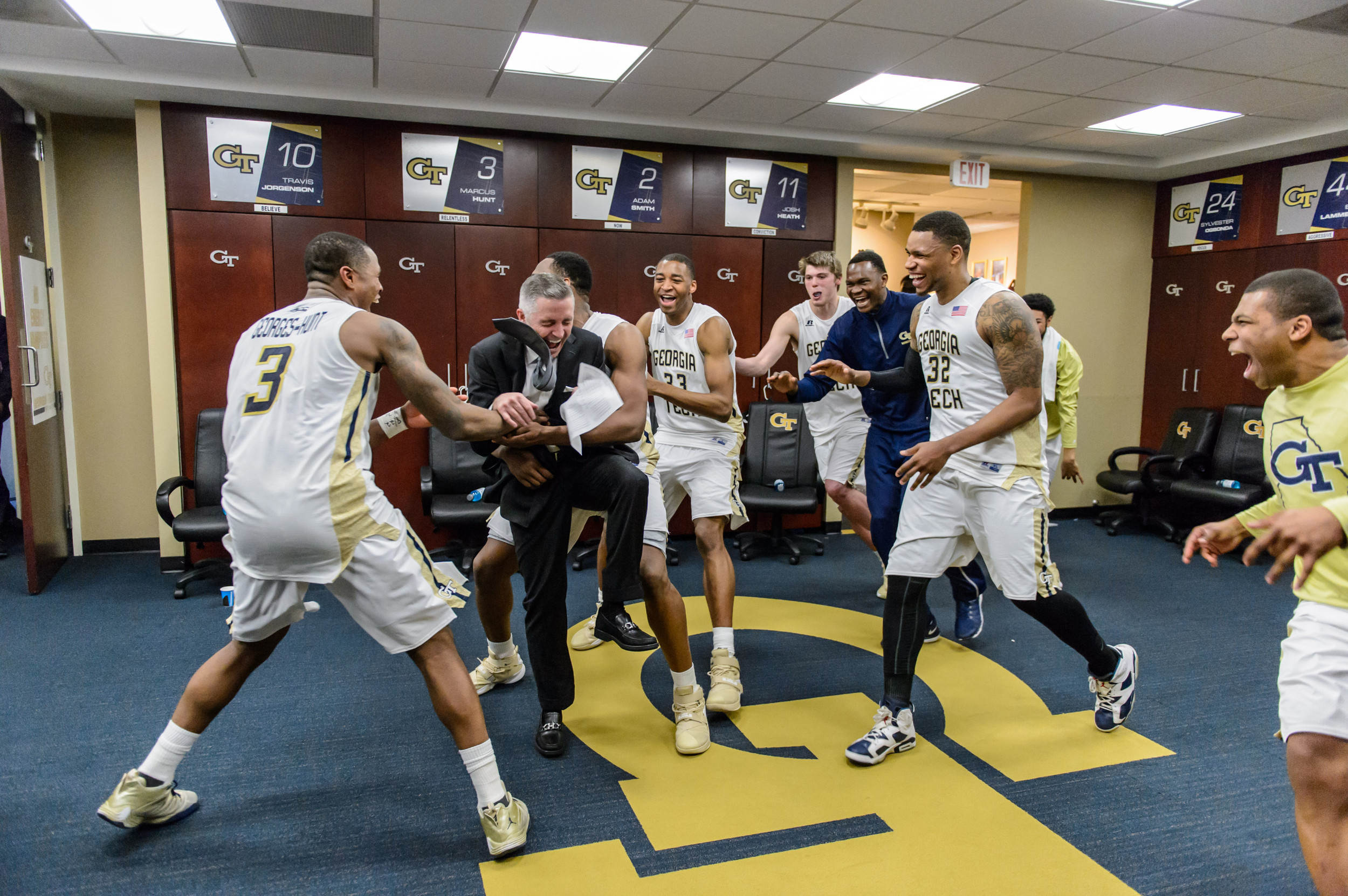 The team celebrates with Coach Gregory after the win
