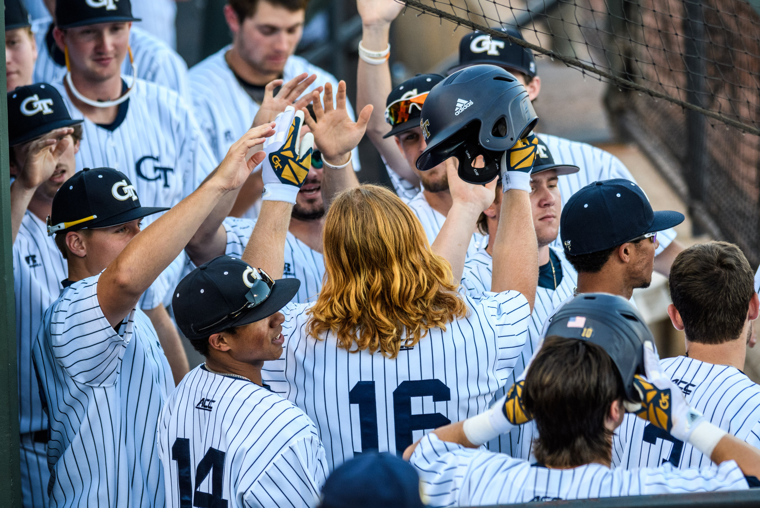 The team congratulates Coleman Poje (16) on his home run