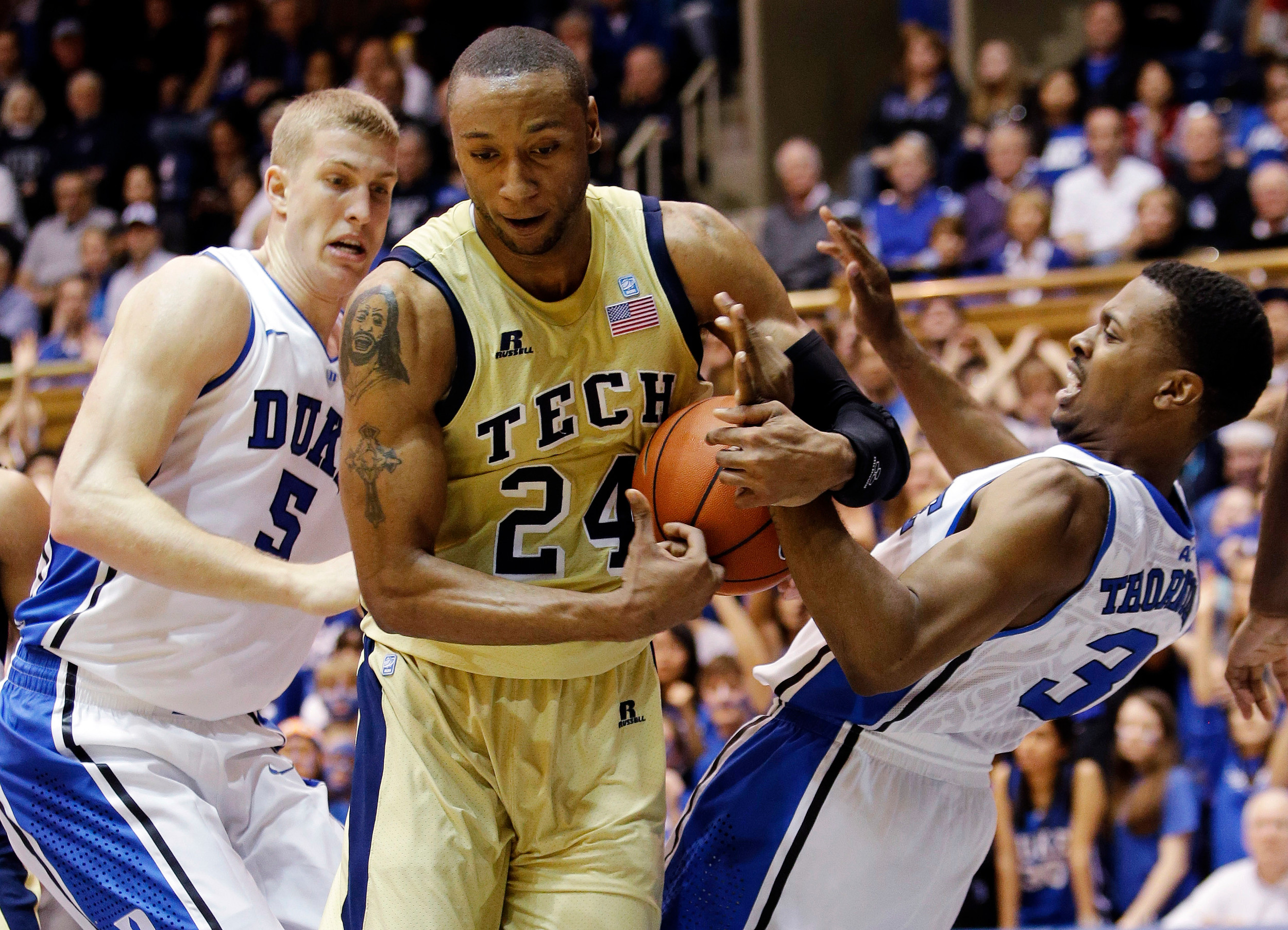 Georgia Tech's Kammeon Holsey (24) for a rebound during the first half. (AP Photo/Gerry Broome)