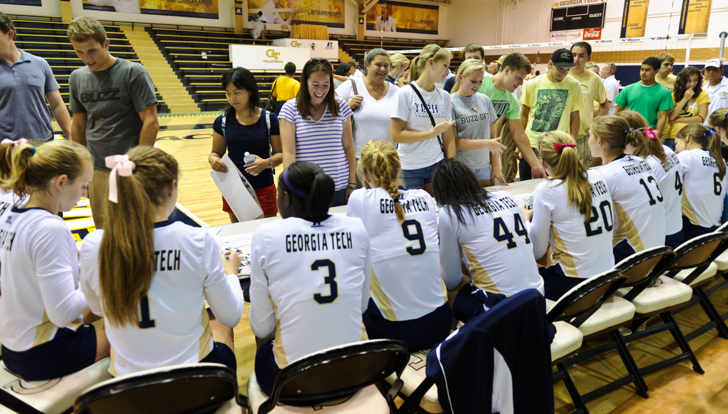 The team signs autographs after the game.