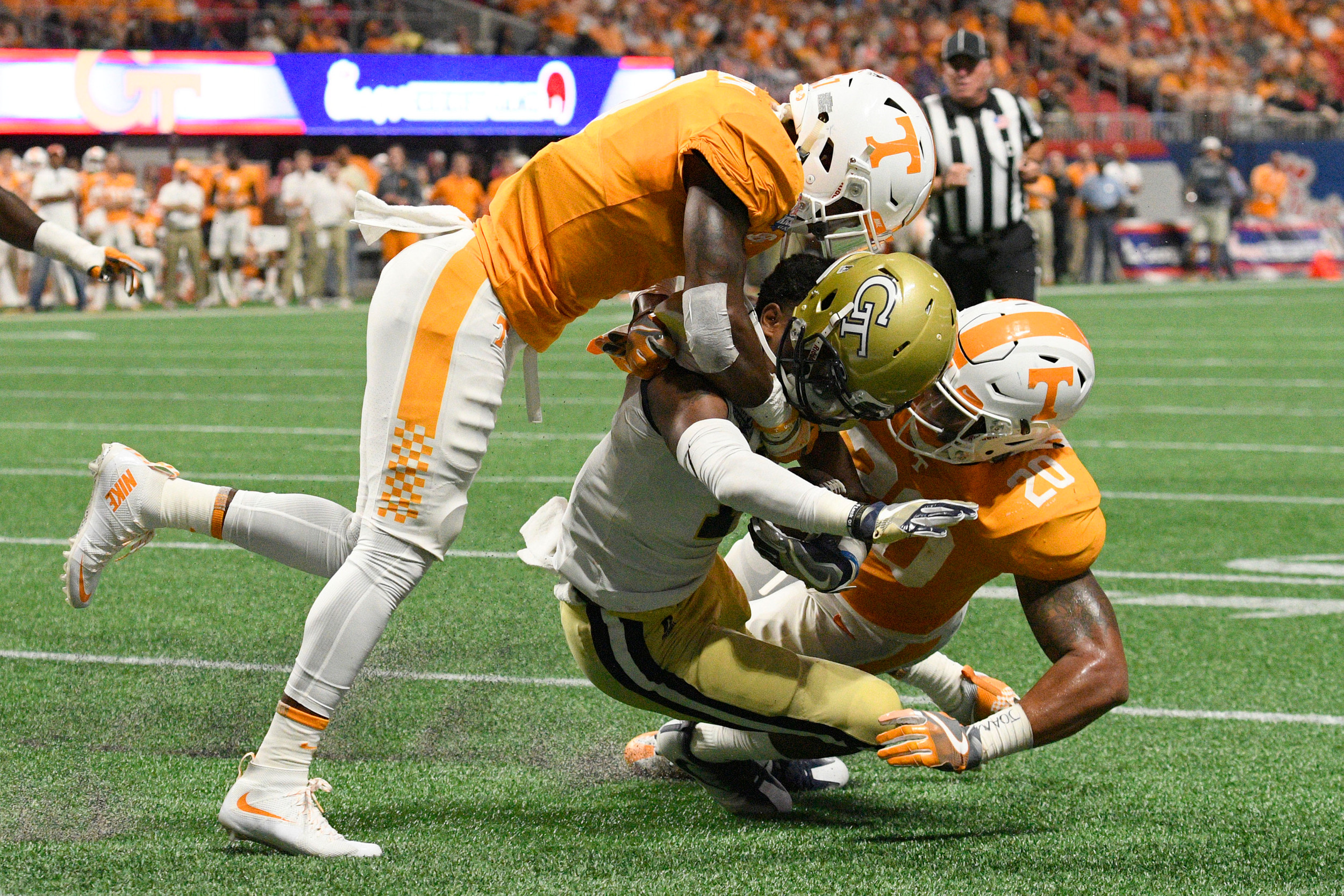 Sep 4, 2017; Atlanta, GA, USA; Georgia Tech Yellow Jackets running back Qua Searcy (1) loses his helmet as he is hit by Tennessee Volunteers defensive back Rashaan Gaulden (7) and linebacker Cortez McDowell (20) during the third quarter at Mercedes-Benz Stadium. Mandatory Credit: Dale Zanine-USA TODAY Sports