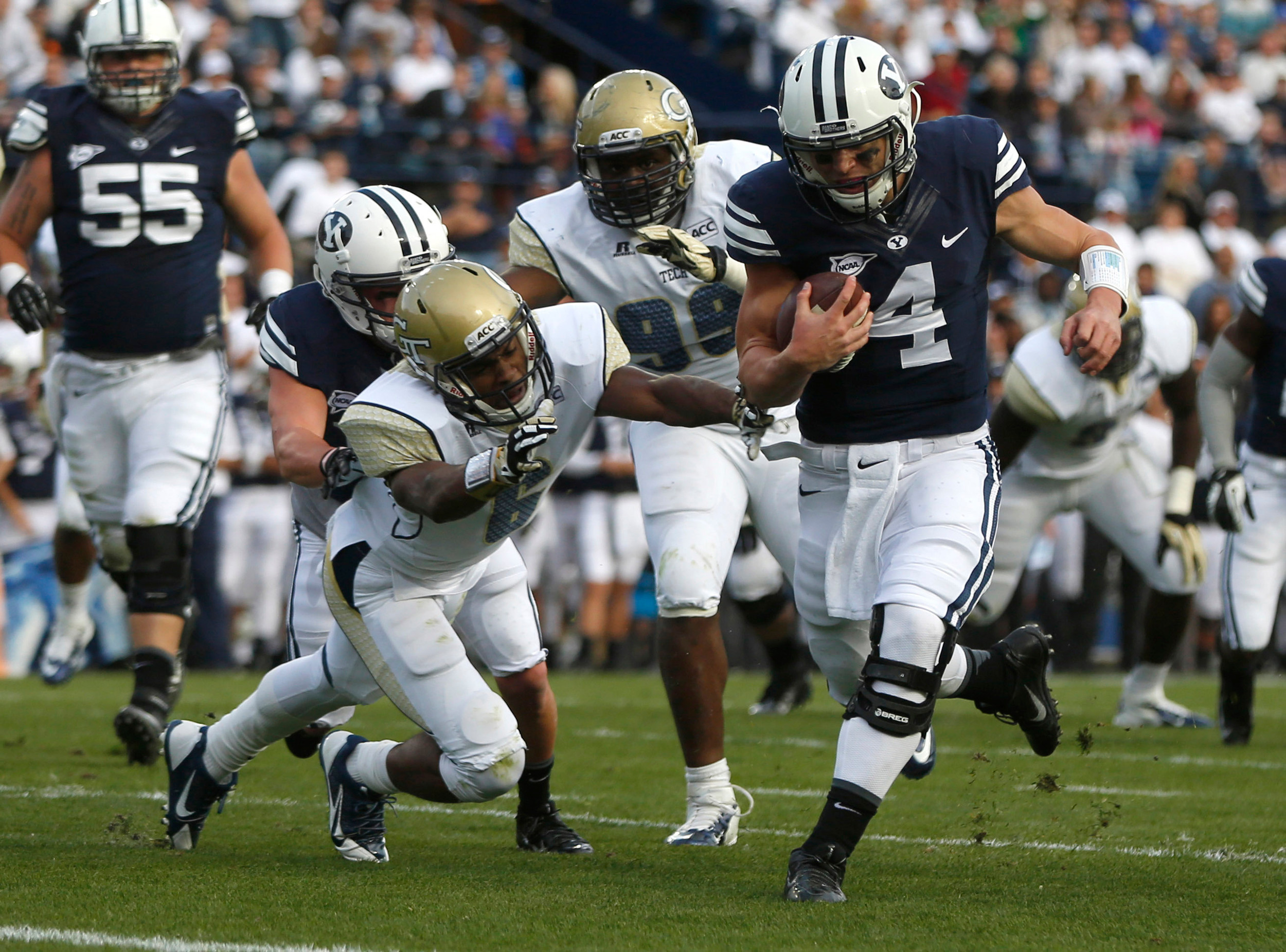 Georgia Tech Yellow Jackets defensive back Chris Milton (6) attempts to tackle Brigham Young Cougars quarterback Taysom Hill (4) during the second quarter of a football game at Lavell Edwards Stadium. (Jim Urquhart-USA TODAY Sports)