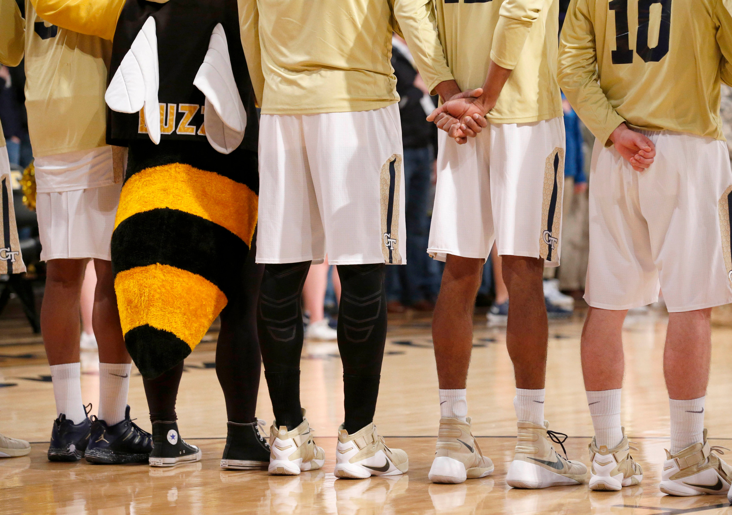 Feb 10, 2016; Atlanta, GA, USA; Georgia Tech Yellow Jackets mascot Buzz stands with Yellow Jackets basketball players during the national anthem. Credit: Jason Getz-USA TODAY Sports