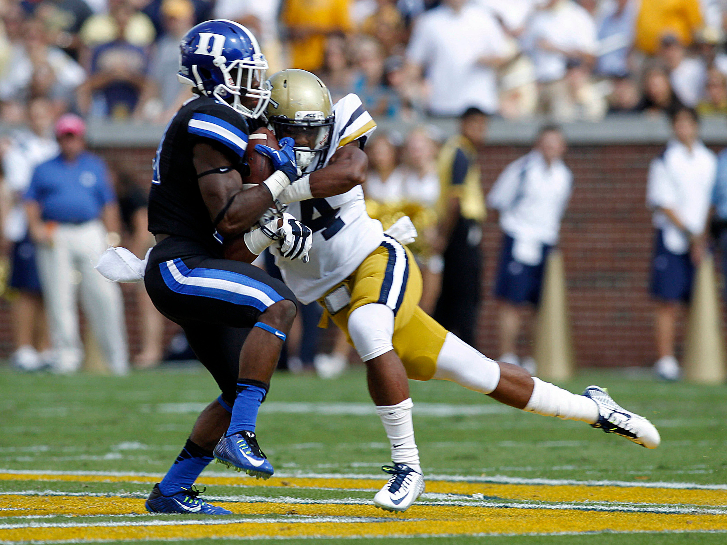 Running back Shaun Wilson (29) is hit by Georgia Tech Yellow Jackets defensive back Jamal Golden (4) in the first quarter at Bobby Dodd Stadium. (Brett Davis-USA TODAY Sports)