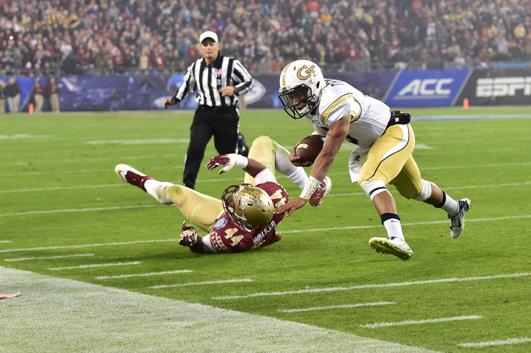 Dec 6, 2014; Charlotte, NC, USA; Georgia Tech Yellow Jackets quarterback Justin Thomas (5) with the ball as Florida State Seminoles defensive end DeMarcus Walker (44) defends in the first quarter at Bank of America Stadium. Mandatory Credit: Bob Donnan-USA TODAY Sports