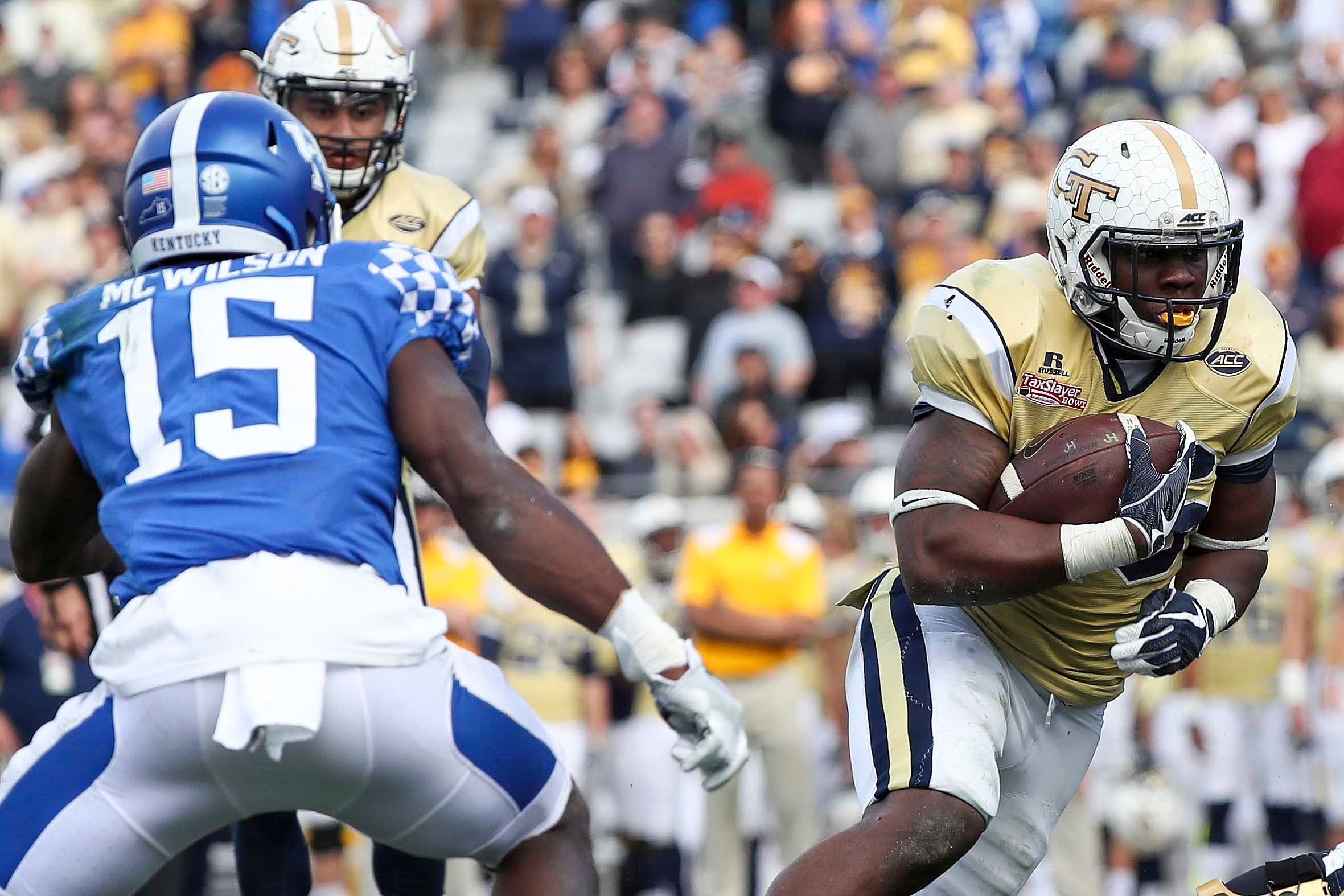Georgia Tech Yellow Jackets running back Dedrick Mills (26) runs for a touchdown in the second half as Kentucky Wildcats safety Marcus McWilson (15) defends at EverBank Field. Logan Bowles-USA TODAY Sports