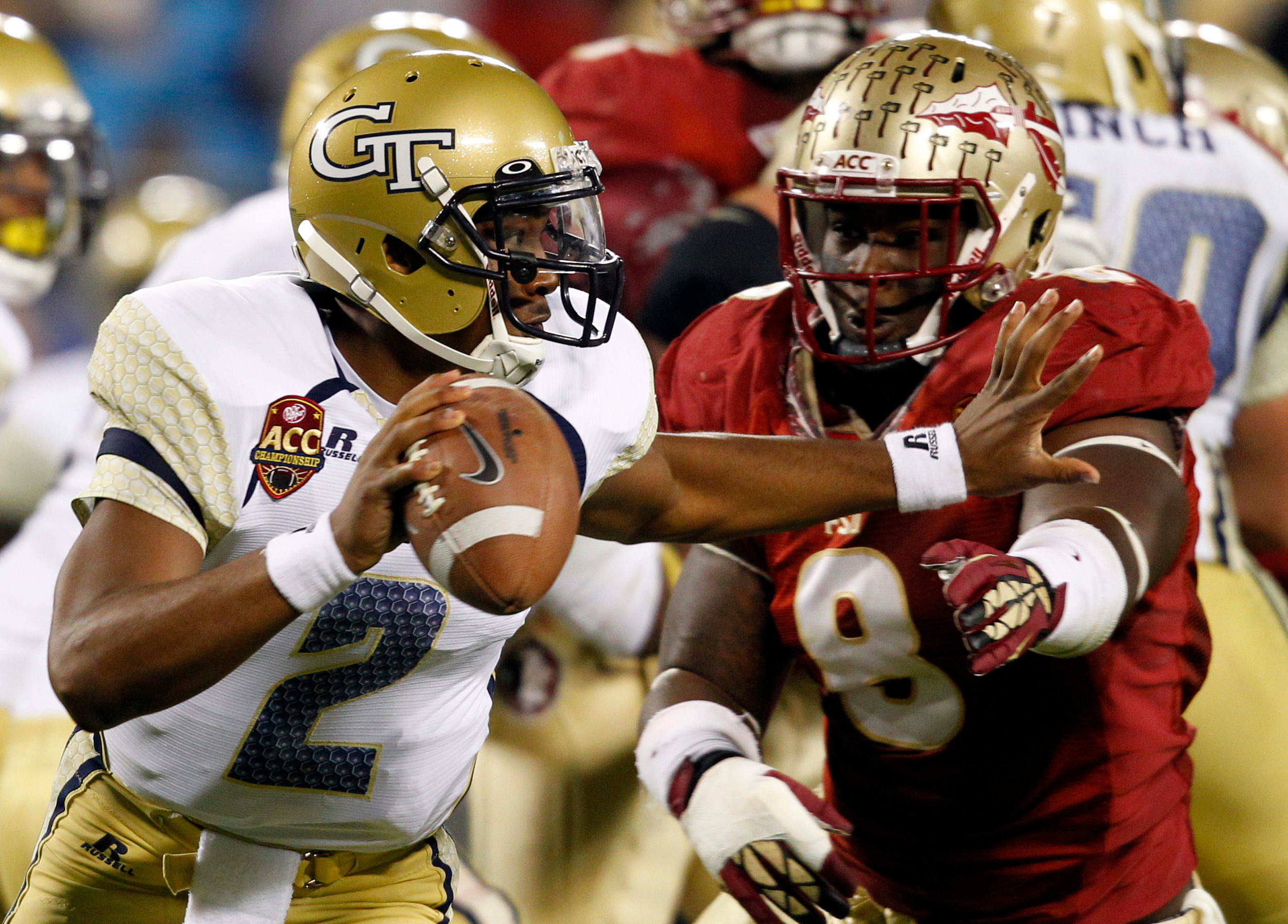 Georgia Tech's Vad Lee (2) tries to scrambles away from Florida State's Timmy Jernigan (8) during the first halfy. (AP Photo/Chuck Burton)