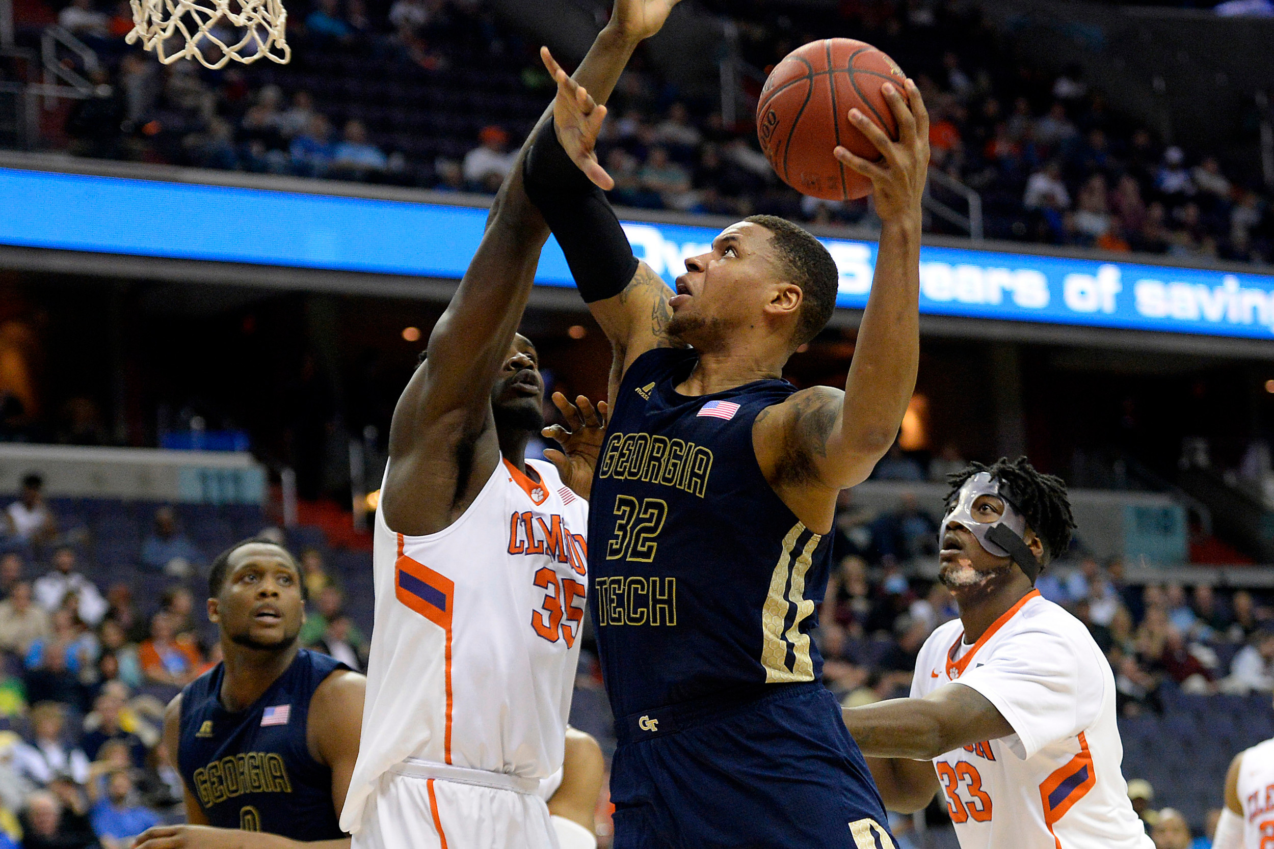 Mar 9, 2016; Washington, DC, USA; Georgia Tech Yellow Jackets forward Nick Jacobs (32) shoots as Clemson Tigers center Landry Nnoko (35) defends in the first half during day two of the ACC conference tournament at Verizon Center. Mandatory Credit: Tommy Gilligan-USA TODAY Sports