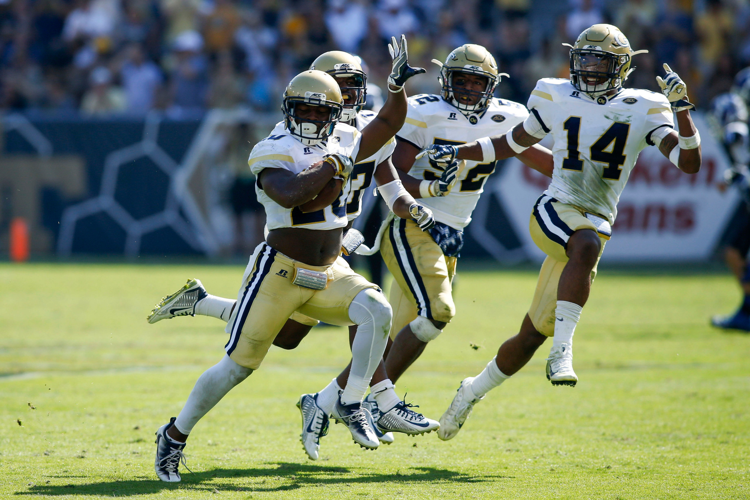 Yellow Jackets defensive back Lawrence Austin (20) celebrates an interception against the Blue Devils with defensive back Lance Austin (17) and linebacker Terrell Lewis (52) and defensive back Corey Griffin (14) in the third quarter at Bobby Dodd Stadium. Brett Davis-USA TODAY Sports