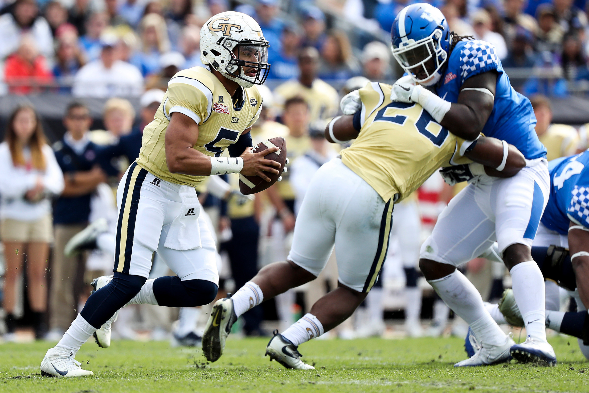 Georgia Tech Yellow Jackets quarterback Justin Thomas (5) looks to run the ball in the second quarter against the Kentucky Wildcats at EverBank Field. Logan Bowles-USA TODAY Sports