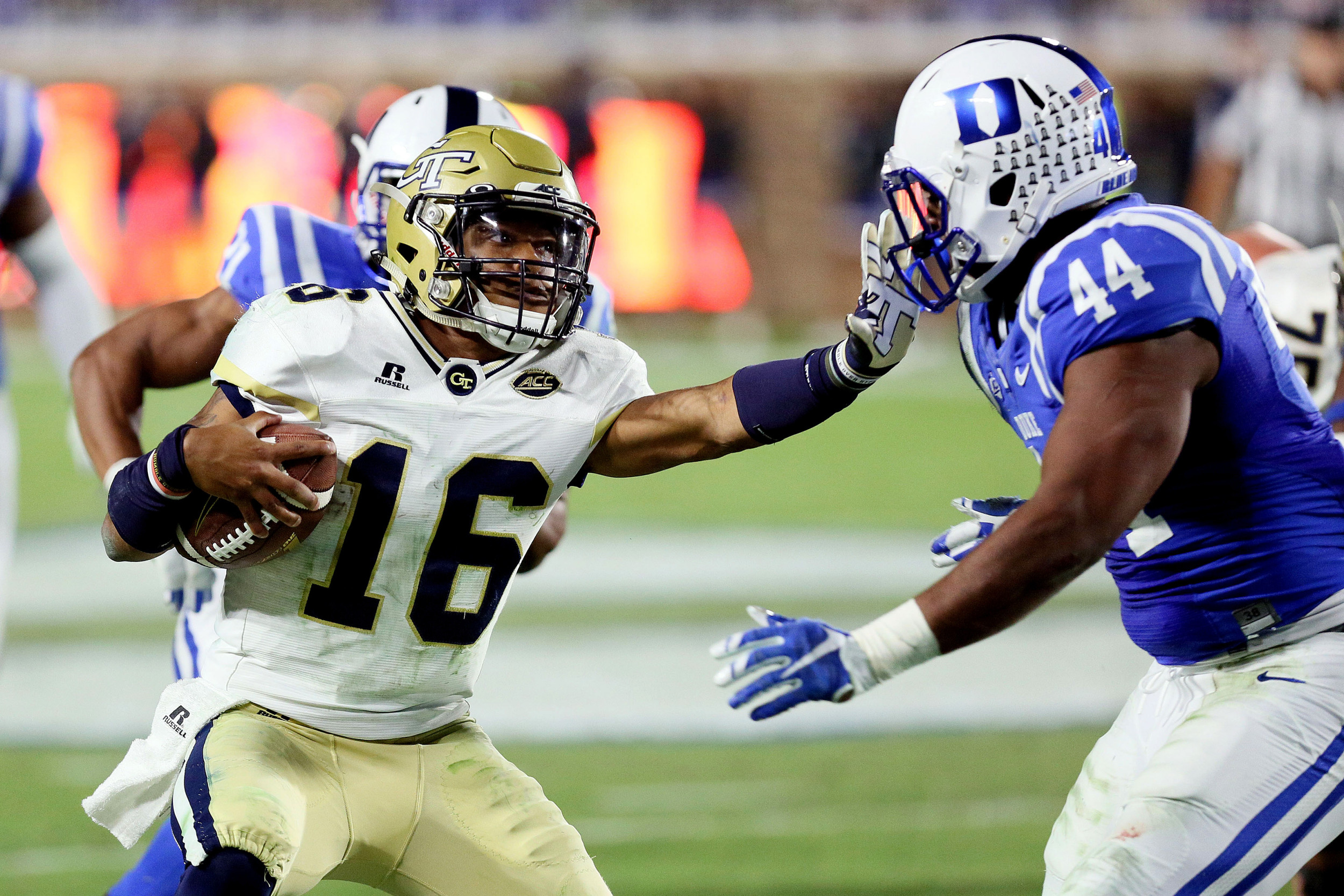Nov 18, 2017; Durham, NC, USA; Georgia Tech Yellow Jackets quarterback TaQuon Marshall (16) stiff arms Duke Blue Devils linebacker Joe Giles-Harris (44) as he keeps the ball for a run in the second half at Wallace Wade Stadium. Duke beat the Georgia Tech 42-20. Mandatory Credit: Mark Dolejs-USA TODAY Sports