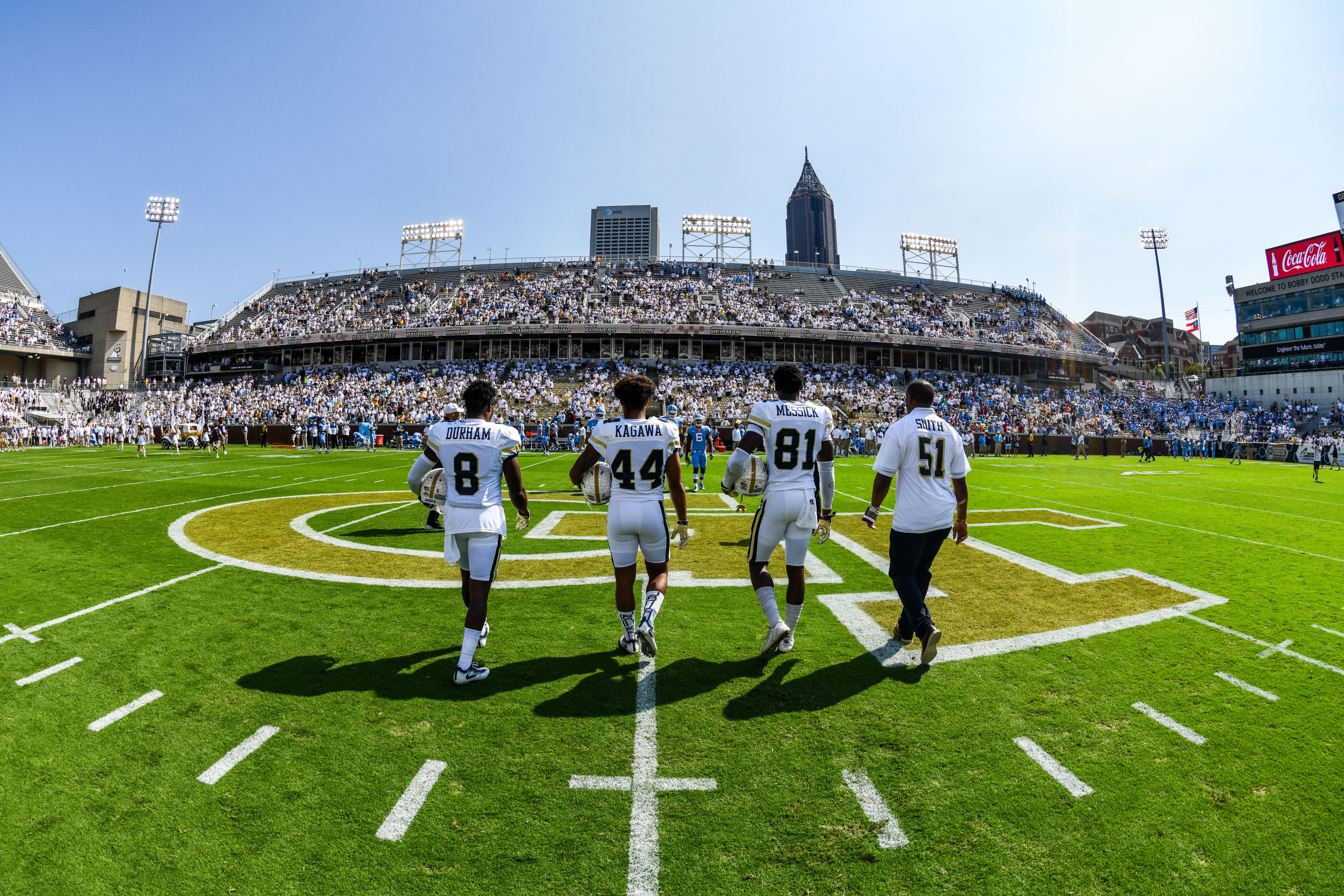 Step Durham (8), Shaun Kagawa (44), and Antonio Messick (81) prepare for the coin toss.