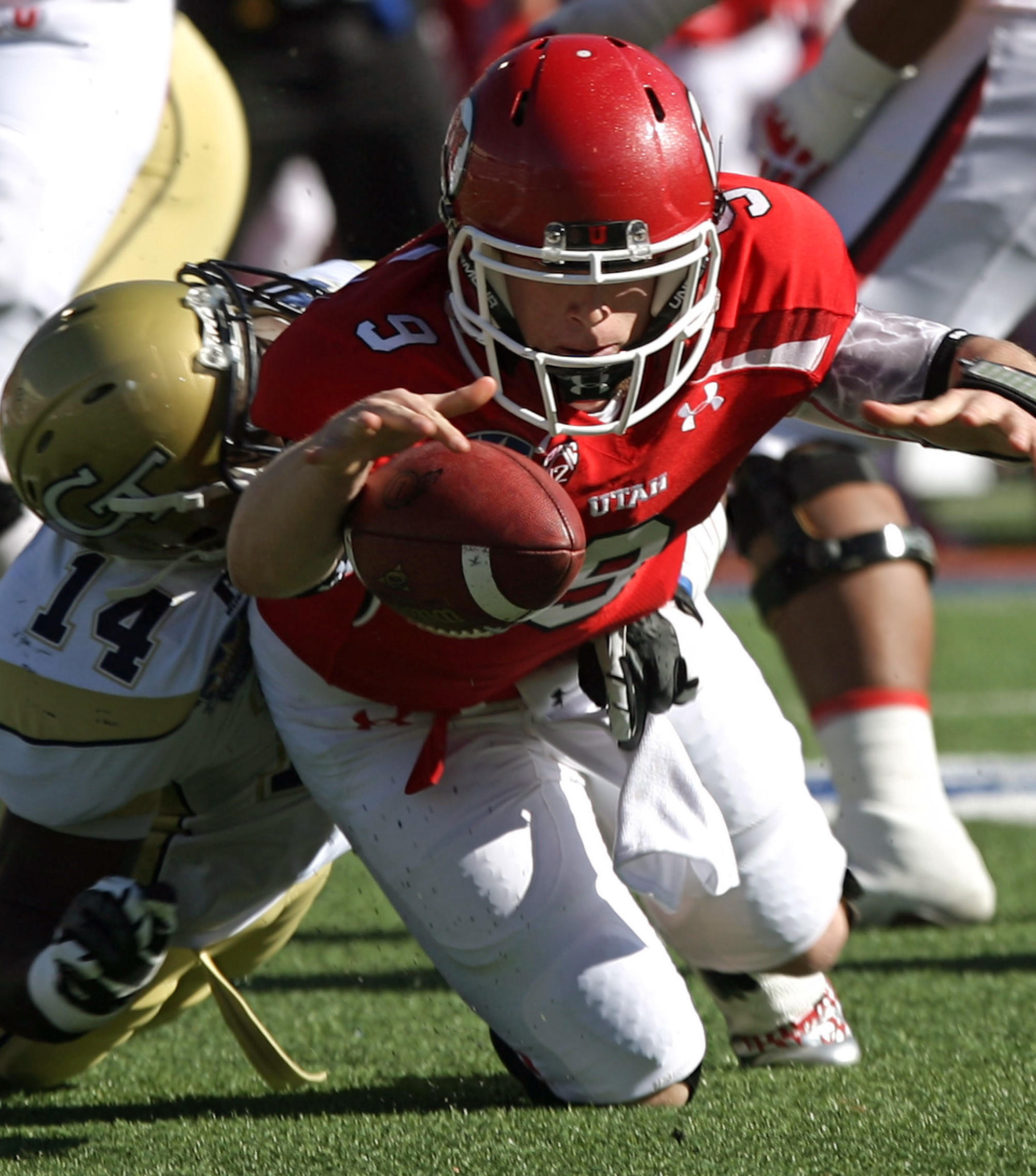Utah quarterback Jon Hays, right, reaches to recover his fumble forced by Georgia Tech's Jemea Thomas, left, during the first quarter of the Sun Bowl NCAA college football game on Saturday, Dec. 31, 2011, in El Paso, Texas. Hays recovered the fumble. (AP Photo/El Paso Times, Victor Calzada) EL DIARIO OUT; JUAREZ MEXICO OUT; IF USE ON LAM OR LAT AND EL DIARIO DE EL PASO OUT