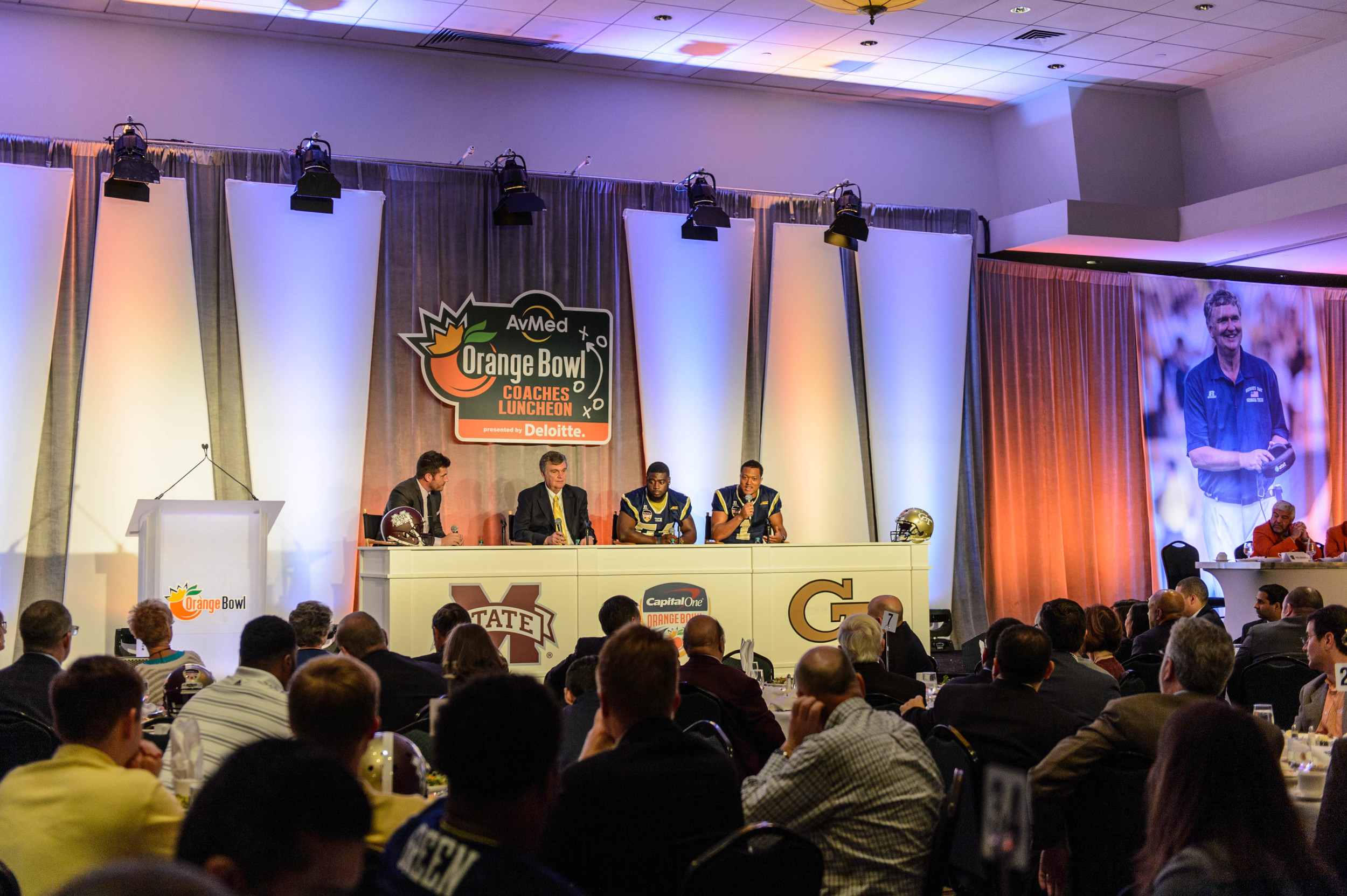 ESPN's Jesse Palmer talks with Coach Paul Johnson, Quayshawn Nealy (54), and Isaiah Johnson (1)