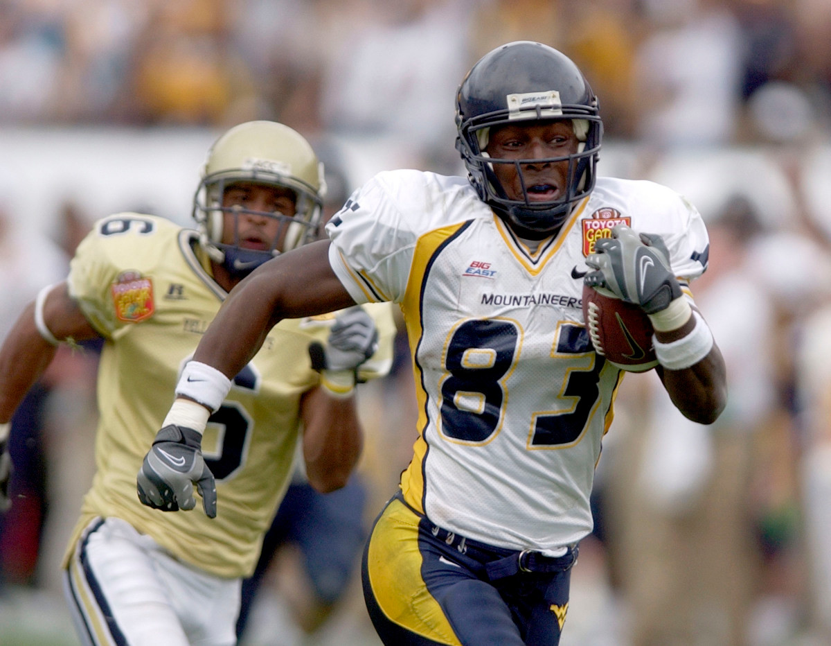 West Virginia wide receiver Tito Gonzales (83) outruns Georgia Tech cornerback Pat Clark (6), on his way to scoring a touchdown during the third quarter of the Gator Bowl college football game, Monday, Jan. 1, 2007, in Jacksonville, Fla. (AP Photo/Stephen Morton)