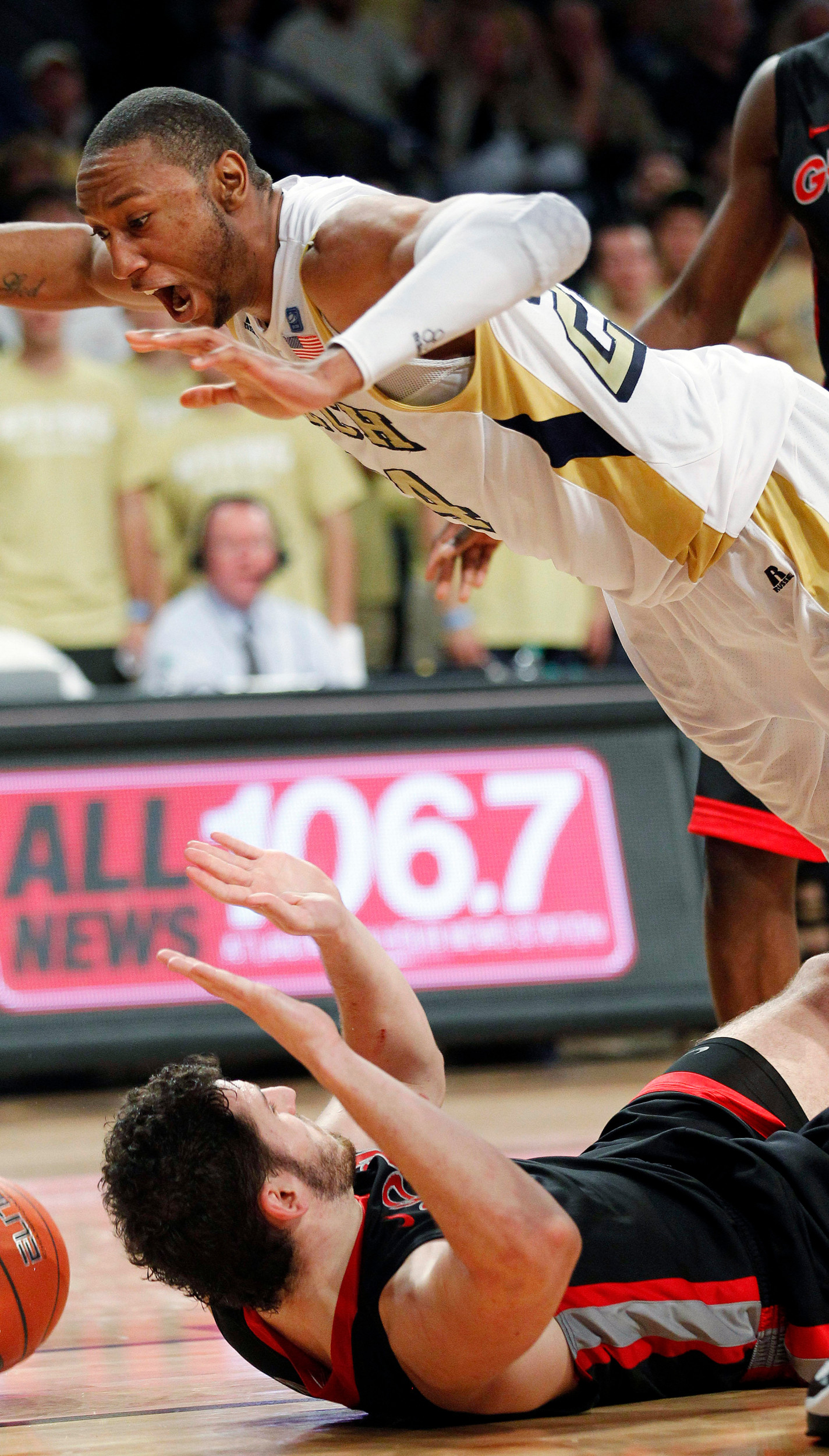 Georgia Tech forward Kammeon Holsey (24) is fouled by Georgia forward Nemanja Djurisic (42) during the second half. (AP Photo/John Bazemore)