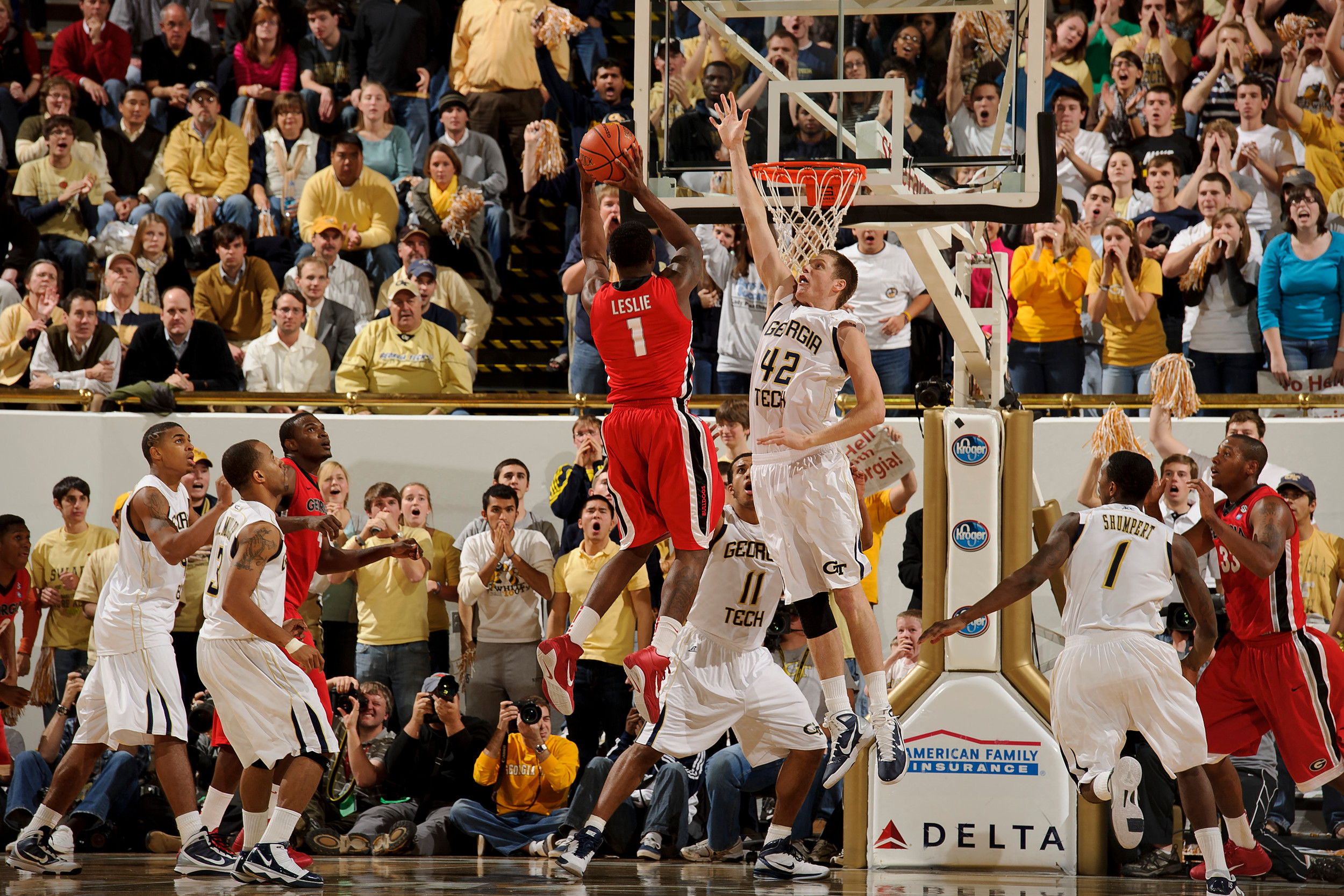 Dec 7, 2010; Atlanta, GA, USA; Georgia Bulldogs guard Travis Leslie (1) pulls up for a shot over Georgia Tech Yellow Jackets center Nate Hicks (42) during the first half at Alexander Memorial Coliseum. Georgia defeated Georgia Tech 73-72. Mandatory Credit: Paul Abell-US PRESSWIRE