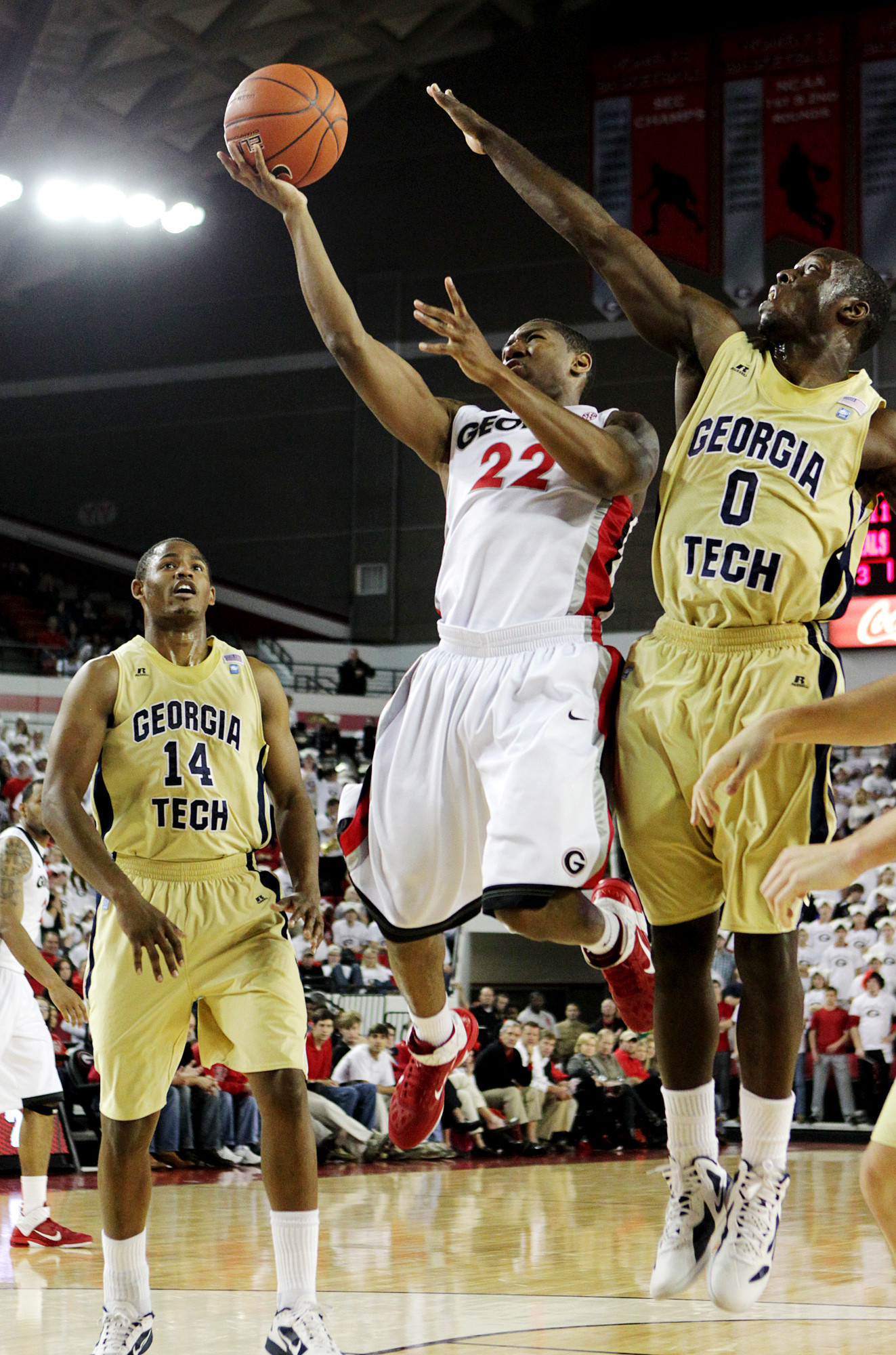Georgia guard Gerald Robinson, Jr., goes for a layup past Georgia Tech guards Mfon Udofia, right, and Jason Morris, left, during the first half of an NCAA college basketball game, Wednesday, Dec. 7, 2011, in Athens, Ga. (AP Photo/Atlanta Journal & Constitution, Curtis Compton) MARIETTA DAILY OUT; GWINNETT DAILY POST OUT