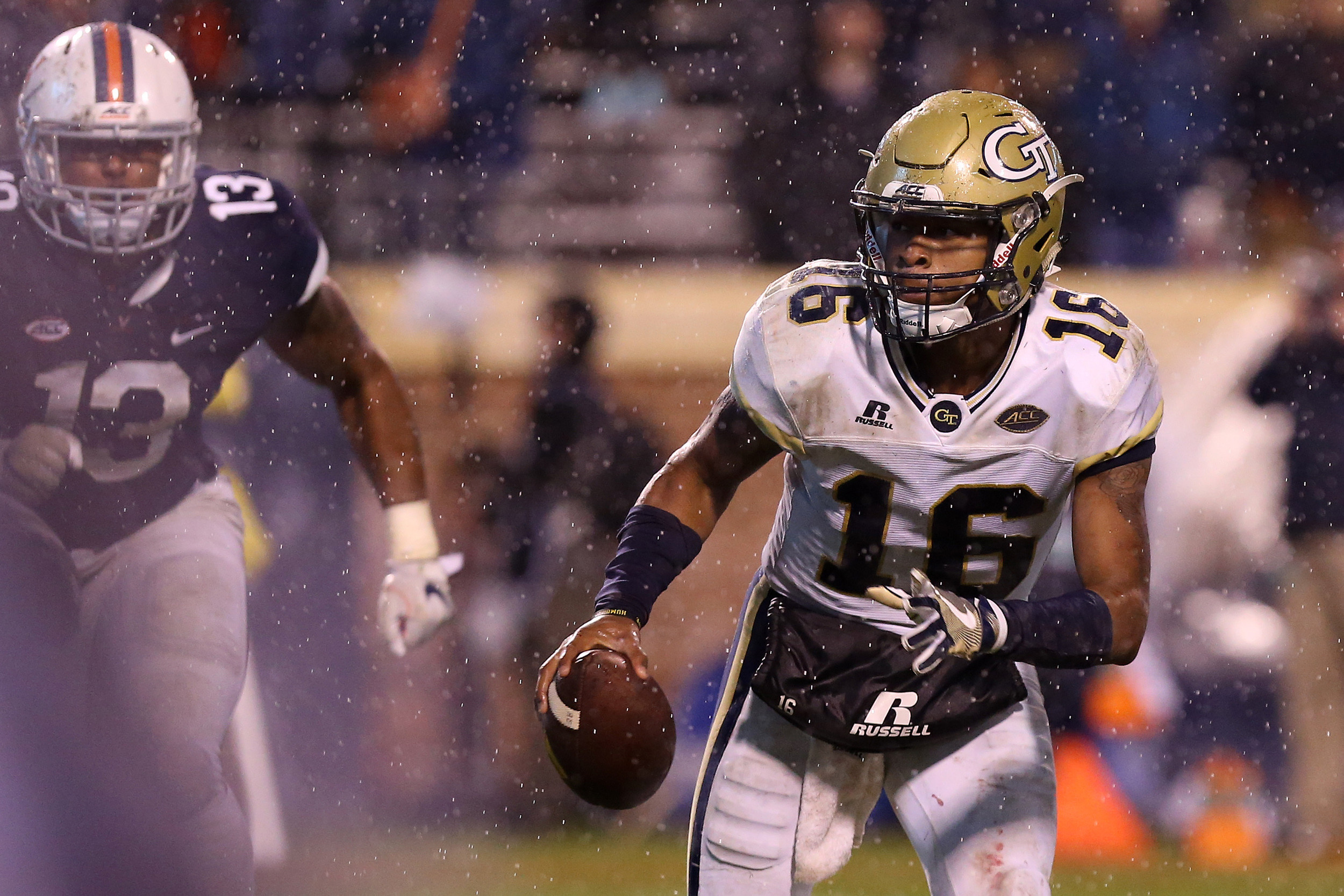 Nov 4, 2017; Charlottesville, VA, USA; Georgia Tech Yellow Jackets quarterback TaQuon Marshall (16) runs with the ball to score on a two-point conversion as Virginia Cavaliers linebacker Chris Peace (13) chases in the fourth quarter at Scott Stadium. The Cavaliers won 40-36. Mandatory Credit: Geoff Burke-USA TODAY Sports