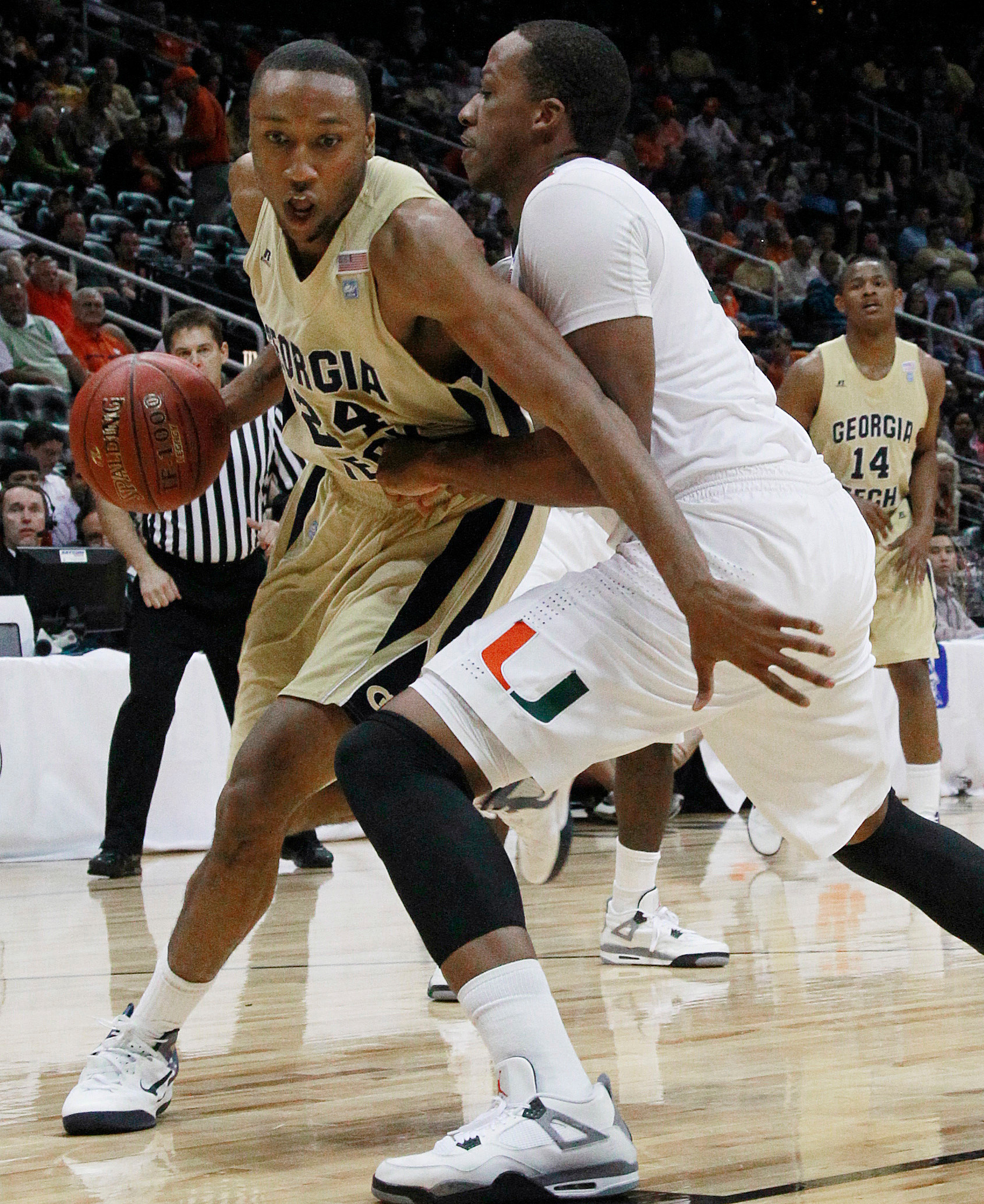 Georgia Tech forward Kammeon Holsey (24) moves around Miami's Kenny Kadji during the first half. (AP Photo/John Bazemore)