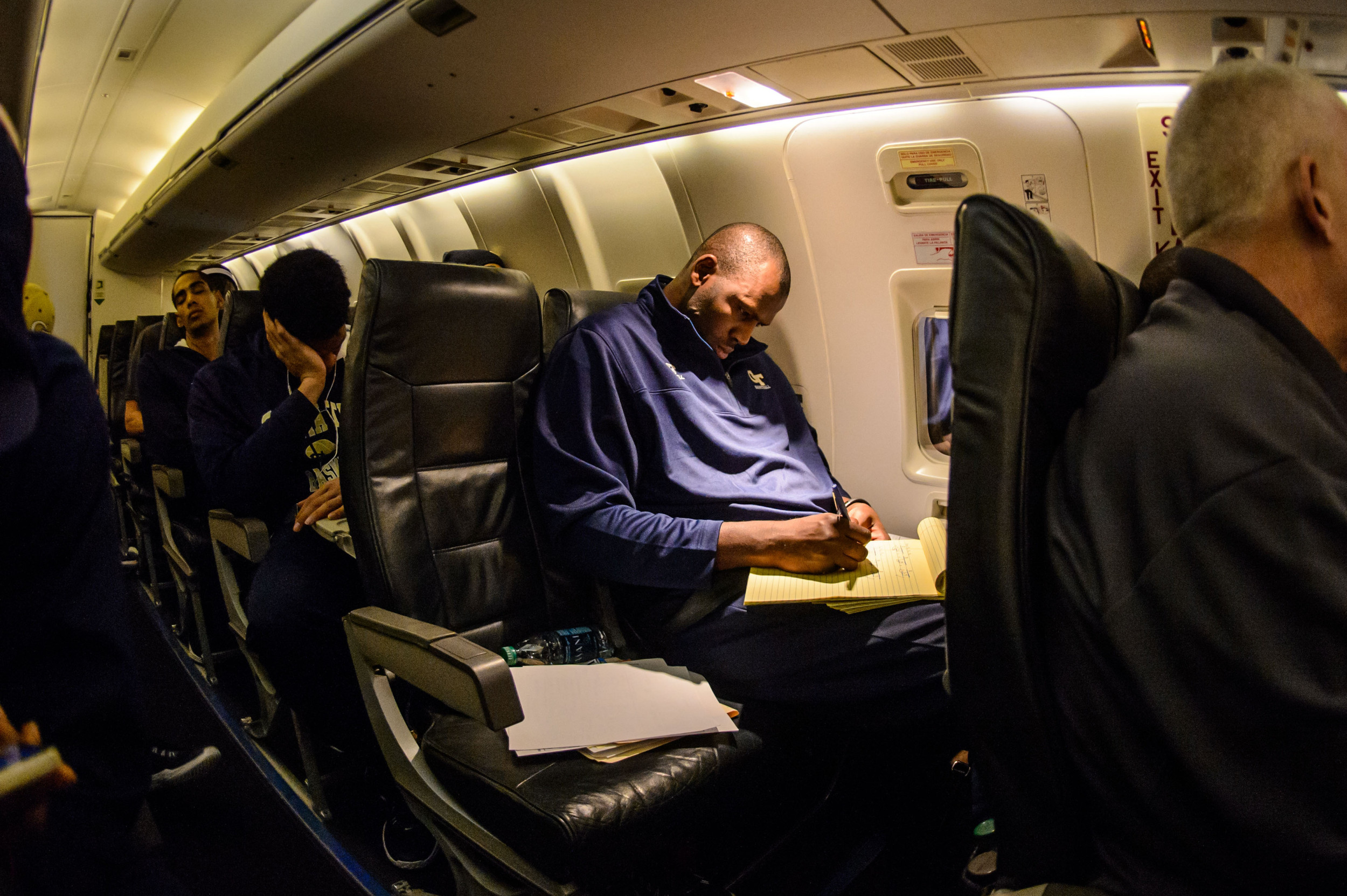 Even on the short flight to Charlottesville, Assistant Coach Mamadou N'Diaye is hard at work.