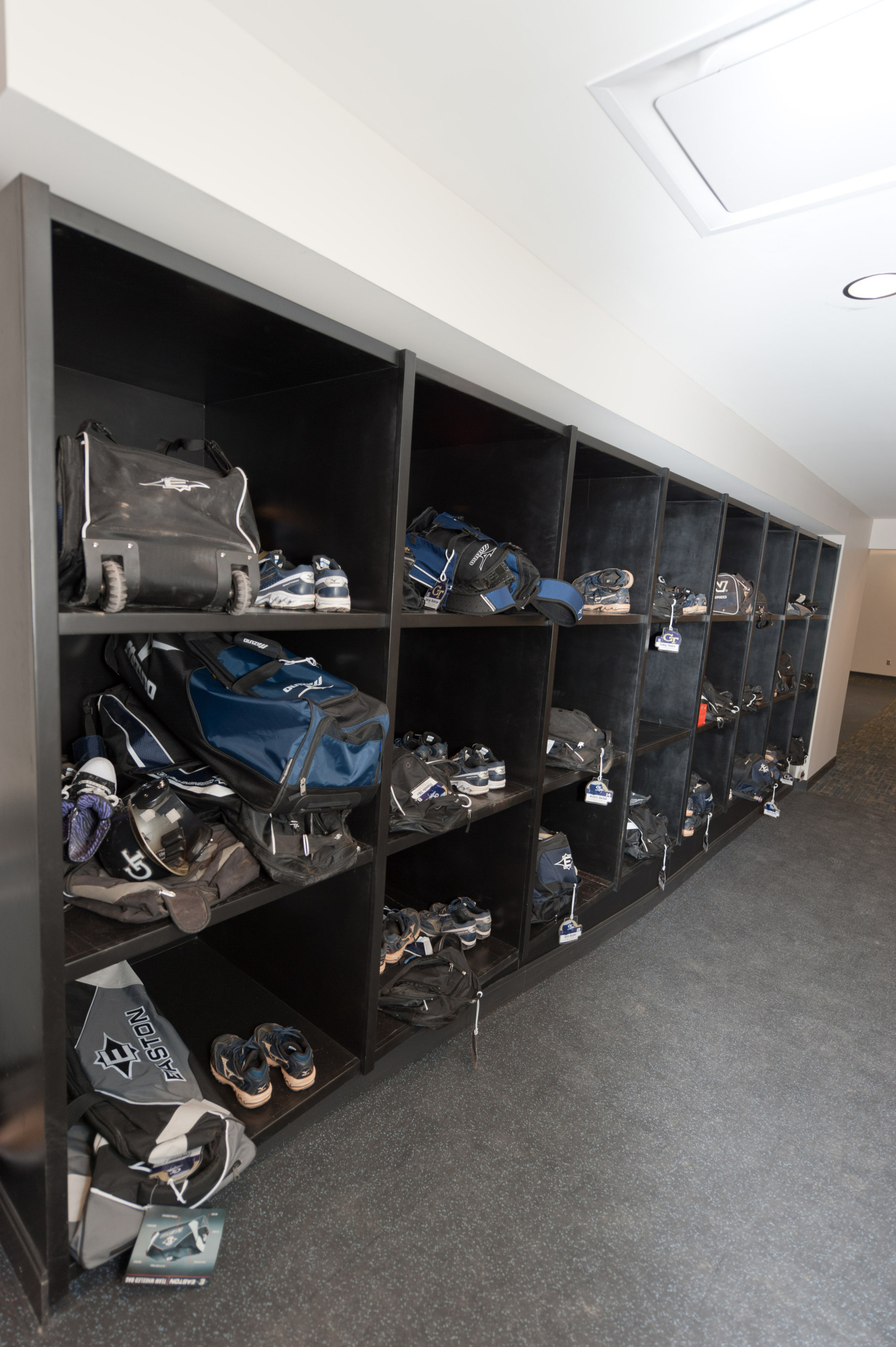 Bat bag and equipment storage racks at the entrance to the new locker room