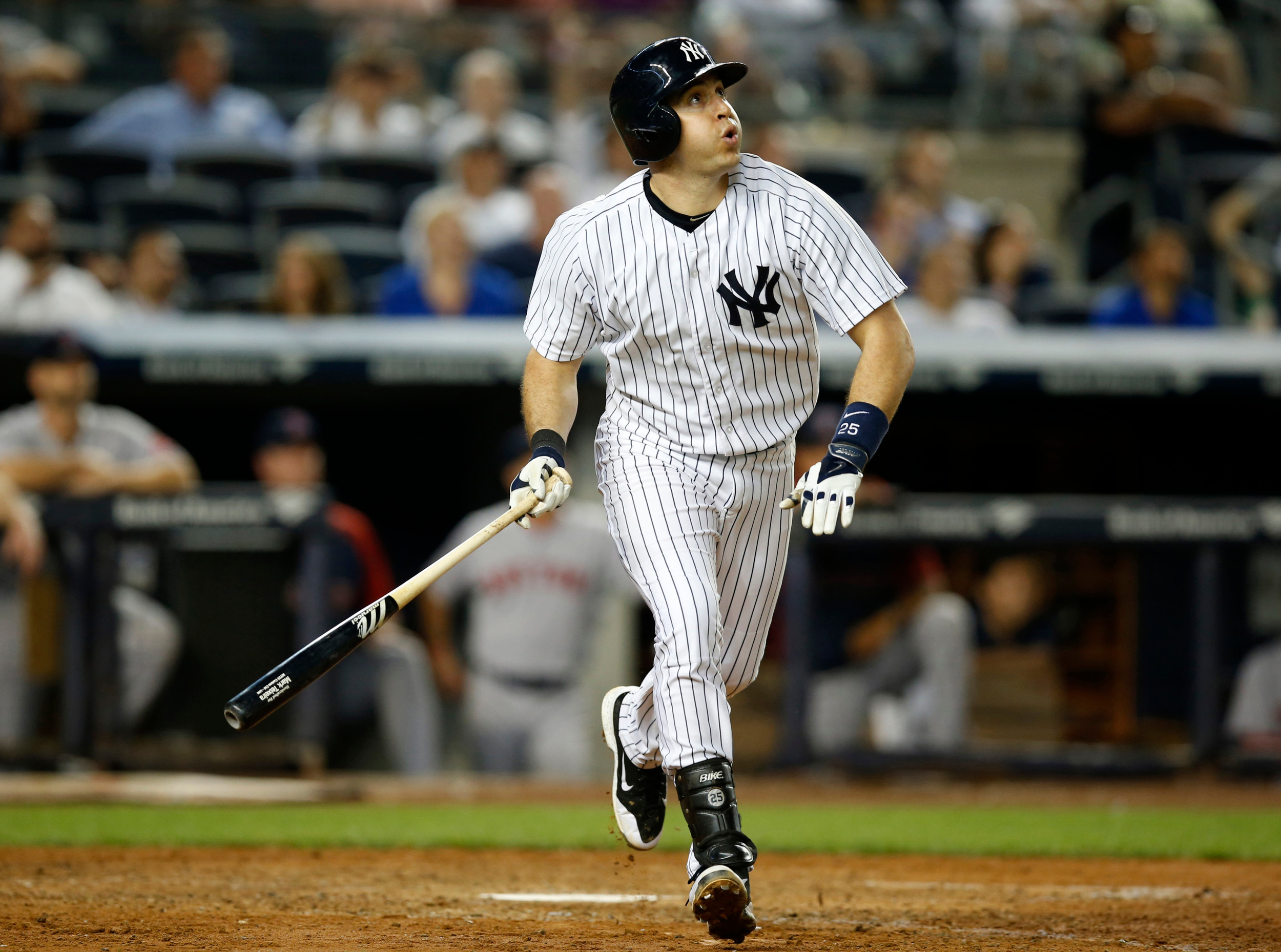 New York Yankees' Mark Teixeira watches his game-tying solo home run off Boston Red Sox relief pitcher Koji Uehara in the ninth inning of the Yankees' 5-4 victory over the Red Sox in a baseball game at Yankee Stadium in New York, Thursday, Sept. 4, 2014. (AP Photo/Kathy Willens)