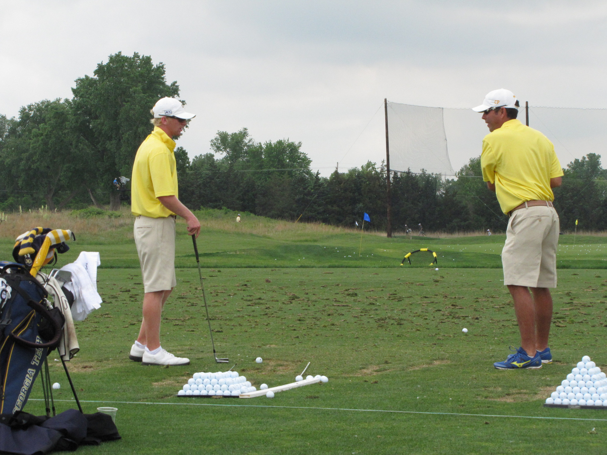 Anders Albertson on the practice range working with assistant coach Brennan Webb - Georgia Tech practices on Sunday at the NCAA Championship - May 25, 2014