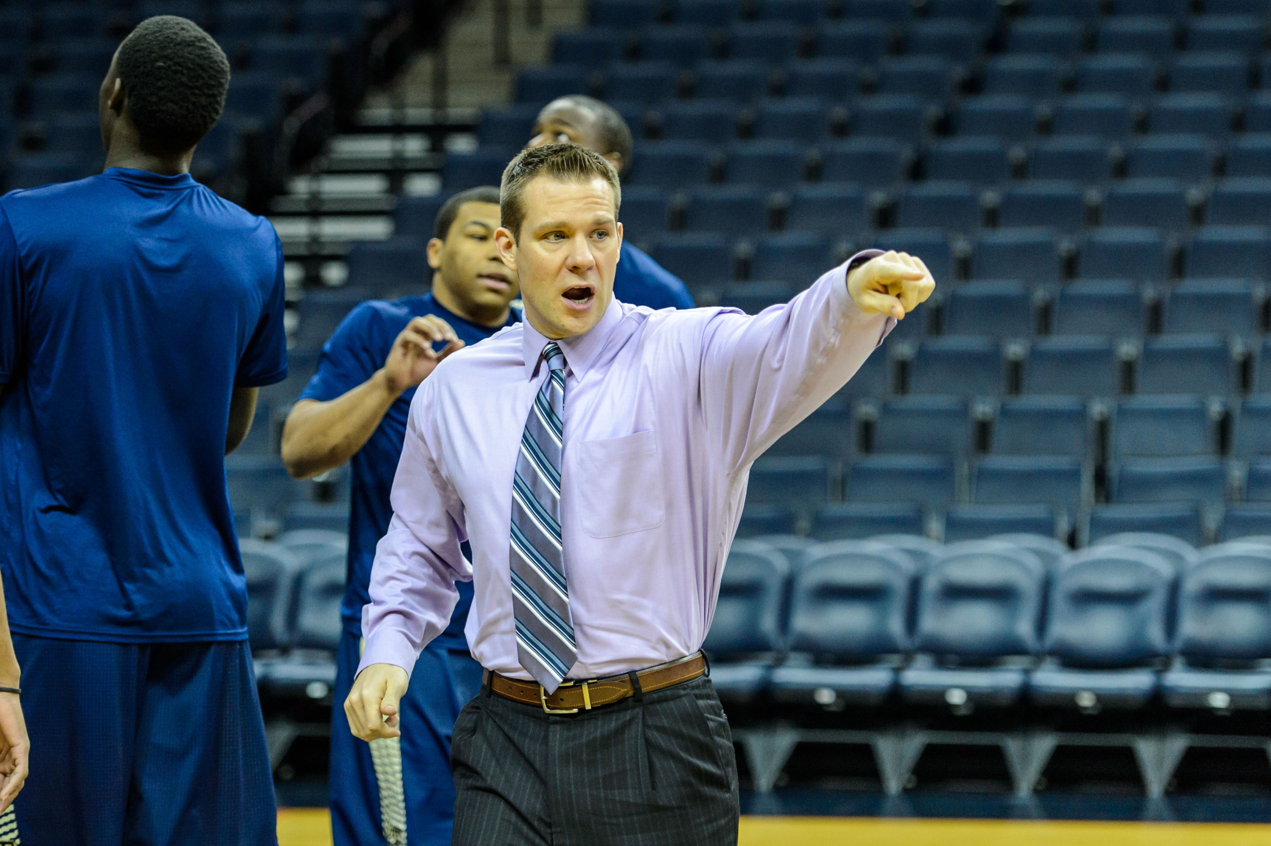 Strength and Conditioning Coach Mike Bewley directs the team on where to stretch.