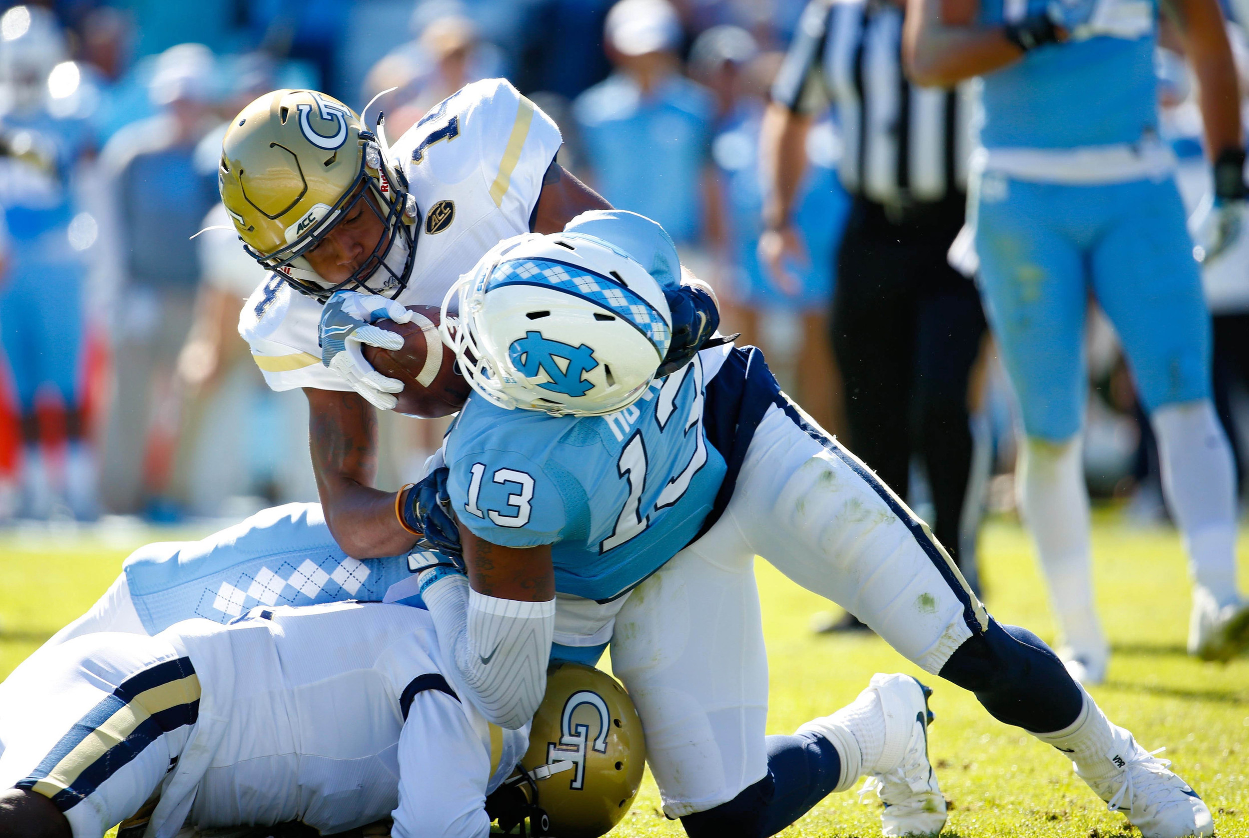 Yellow Jackets defensive back Corey Griffin (14) tackles North Carolina Tar Heels wide receiver Bug Howard (13) after his first quarter catch at Kenan Memorial Stadium. Credit: James Guillory-USA TODAY Sports