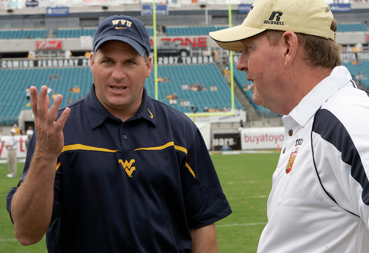 West Virginia head coach Rich Rodriguez, left, talks with Georgia Tech head coach Chan Gailey prior to the start of the Gator Bowl football game, Monday, Jan. 1, 2007, in Jacksonville, Fla.(AP Photo/Steve Cannon)