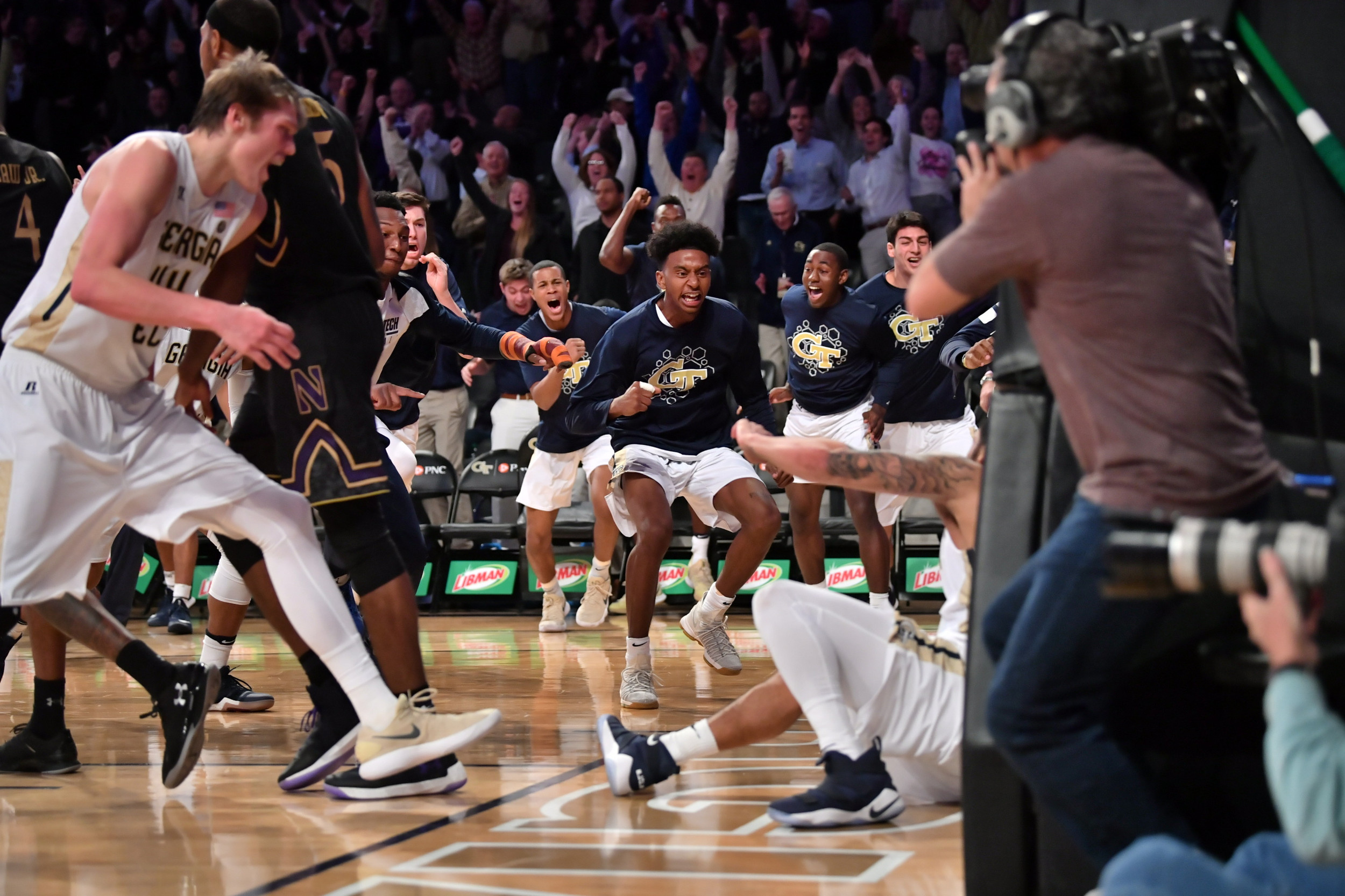 The team swarms Tadric Jackson (1) after the buzzer beater