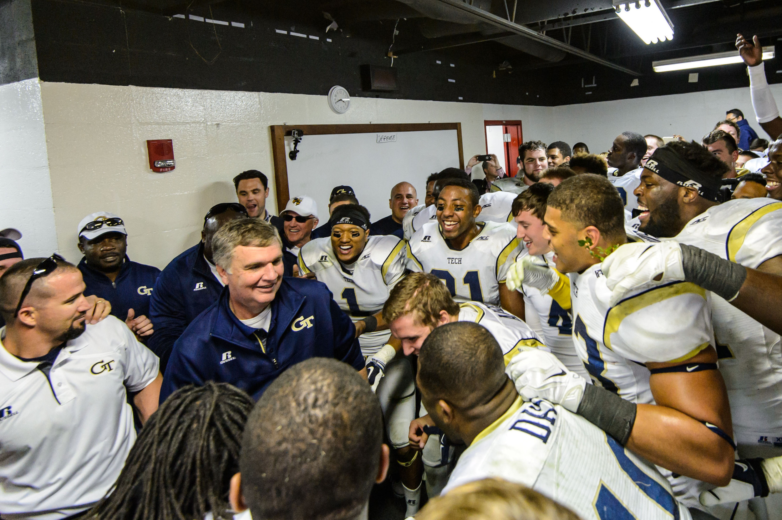 Coach Johnson and the team celebrate the big win over UGA in the locker room