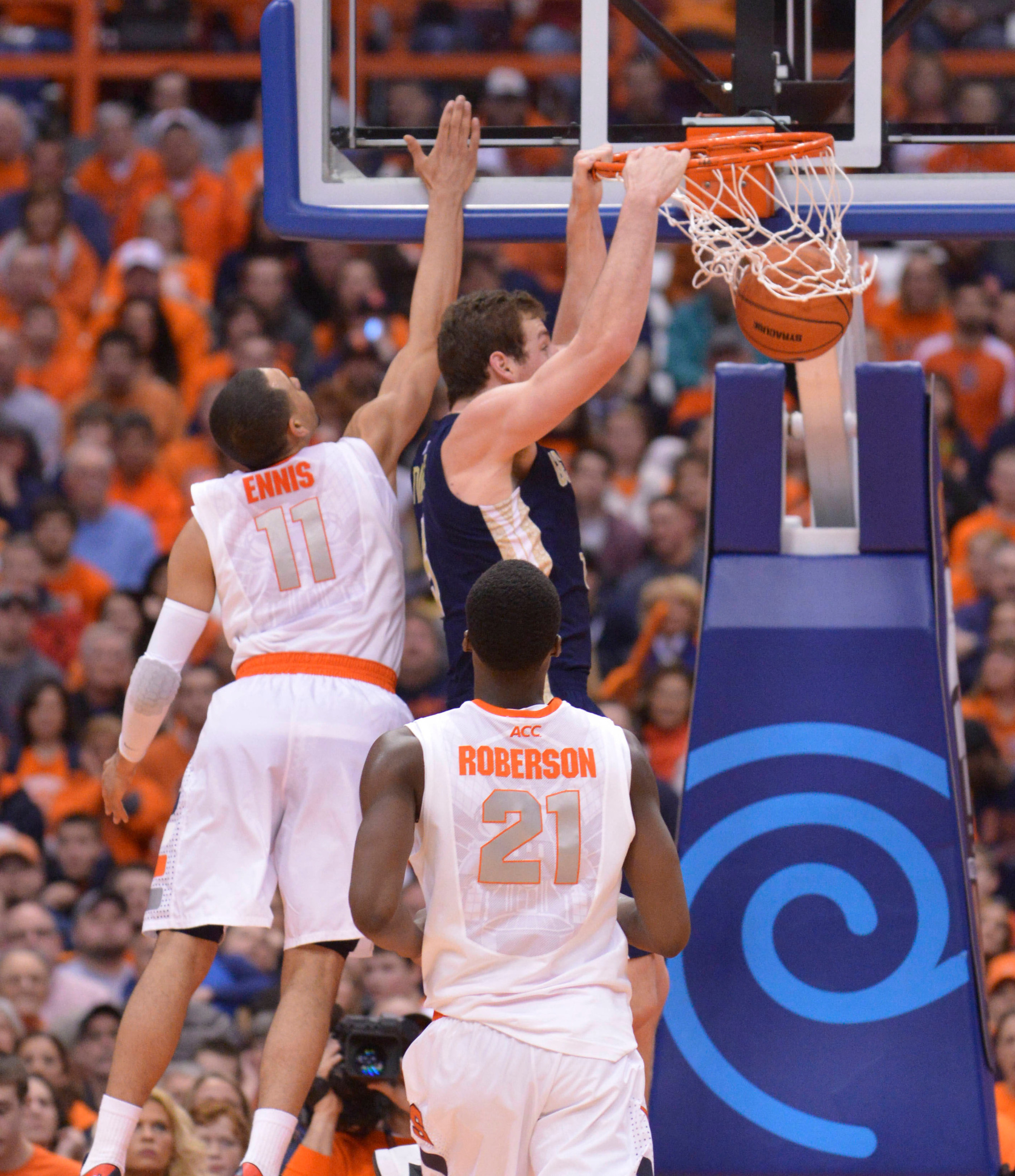 Mar 4, 2014; Syracuse, NY, USA; Georgia Tech Yellow Jackets center Daniel Miller (5) dunks the ball with Syracuse Orange guard Tyler Ennis (11) and forward Rakeem Christmas (25) defending during the second half of a game at the Carrier Dome. Georgia Tech won the game 67-62. Mandatory Credit: Mark Konezny-USA TODAY Sports
