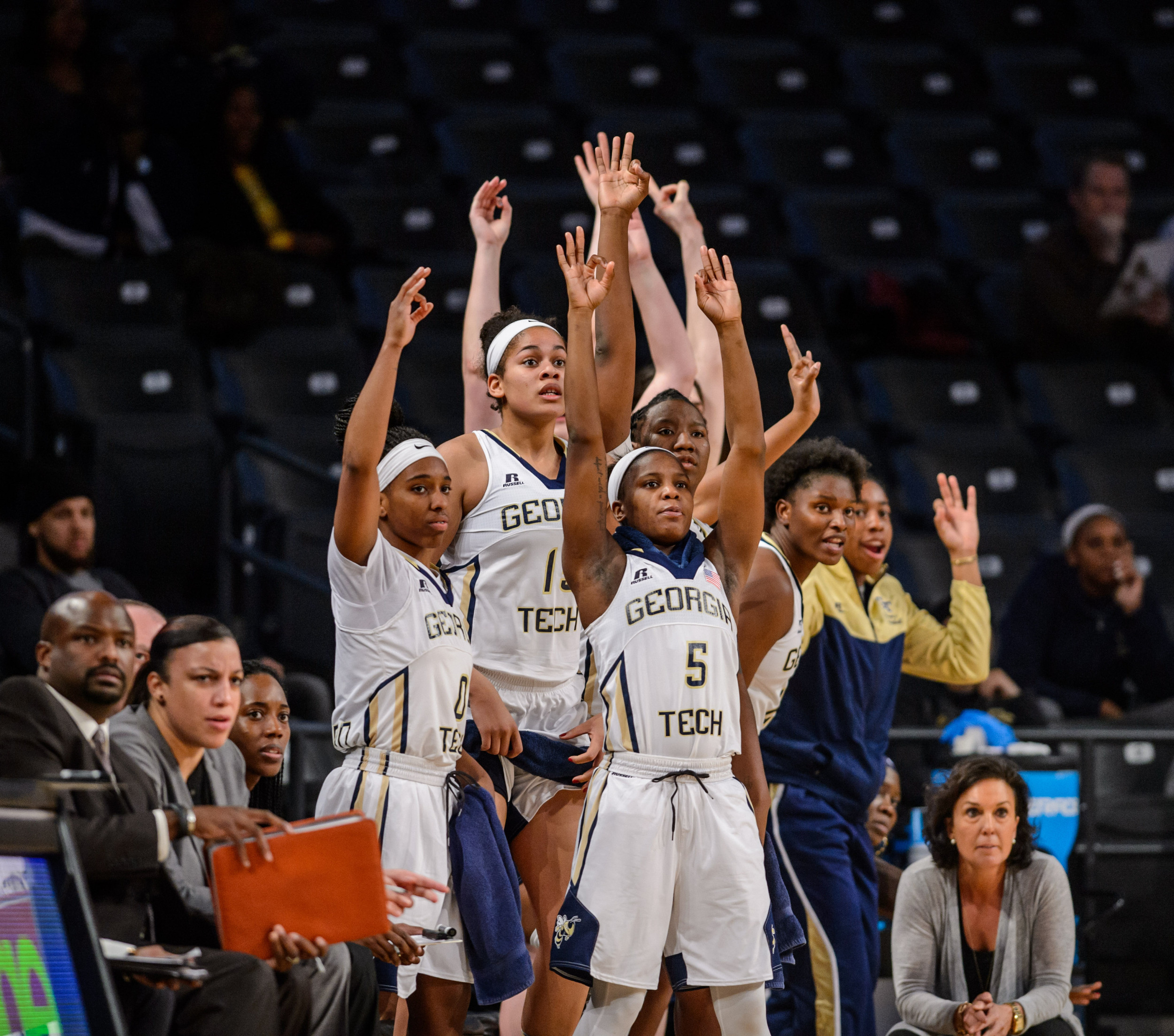 The bench celebrates a three point basket
