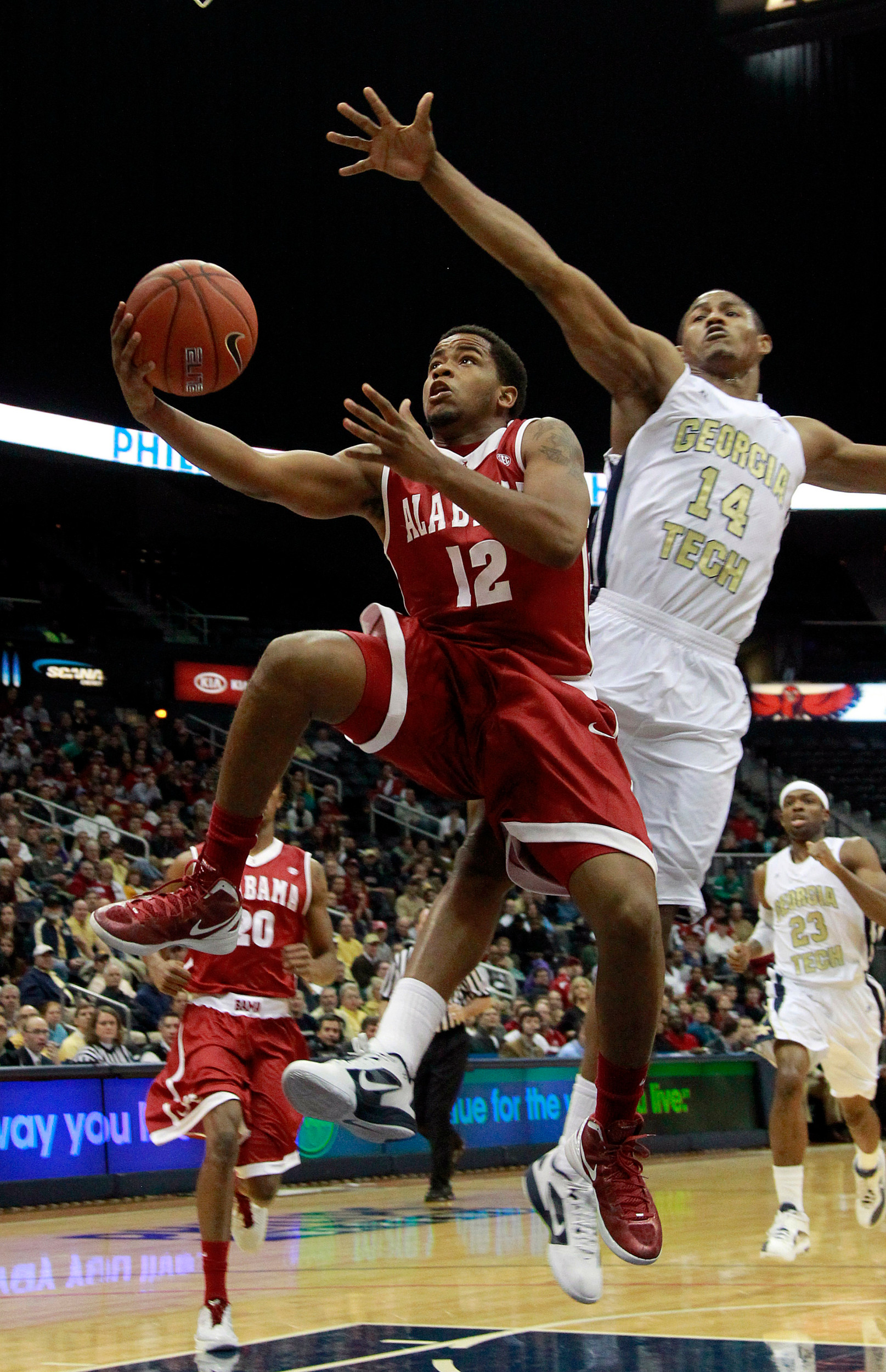 Alabama guard Trevor Releford (12) drives to the basket as Georgia Tech's Jason Morris (14) defends in the first half of an NCAA college basketball game in Atlanta, Tuesday, Jan. 3, 2012. (AP Photo/John Bazemore)