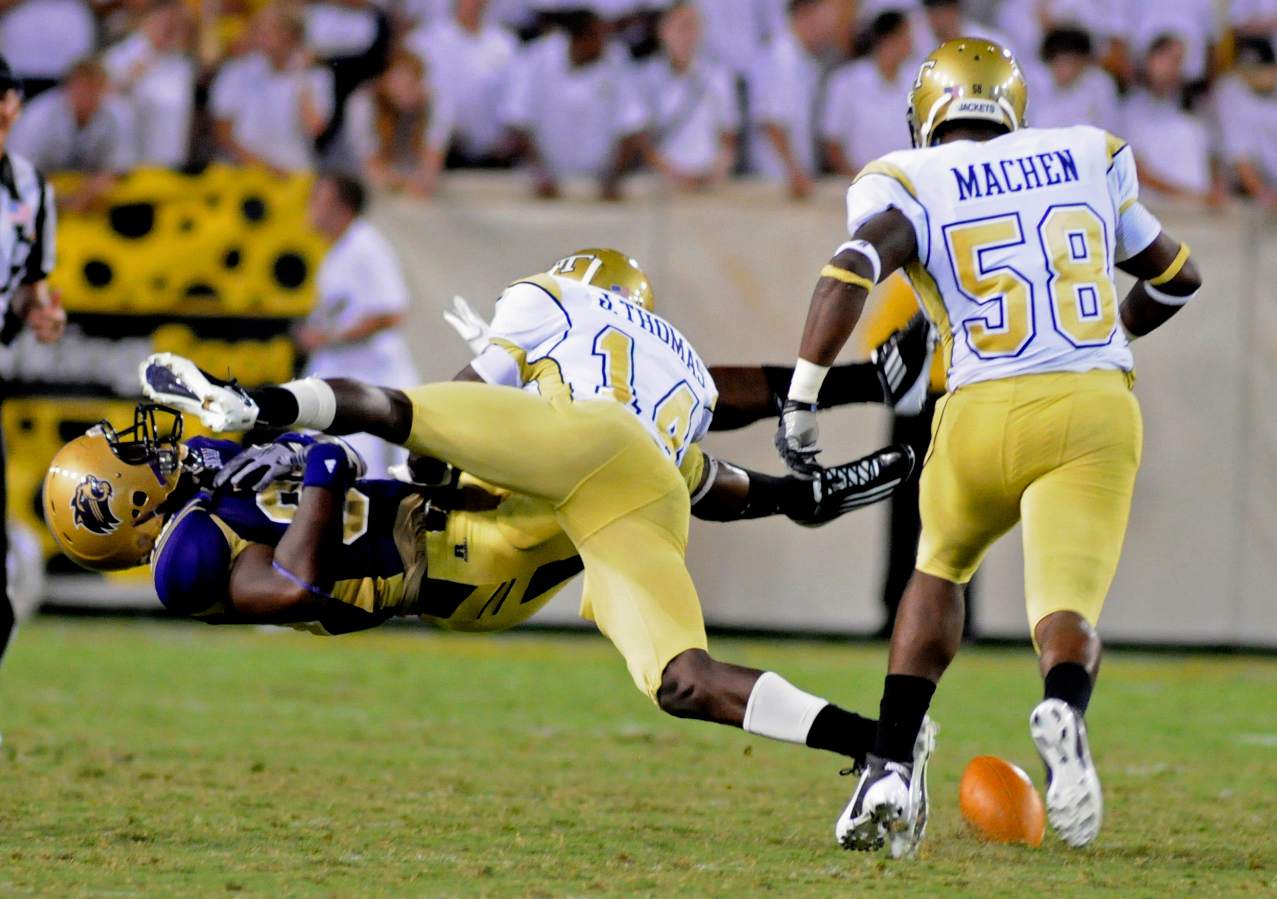 Western Carolinas tight end Nate Stephenson (88) is defended by Georgia Tech defensive back Jemea Thomas (14) and linebacker B.J. Machen (58) during an NCAA college football in Atlanta, Thursday, Sept. 1, 2011. Thomas was called for a personal foul on the play. (AP Photo/Billy Weeks)