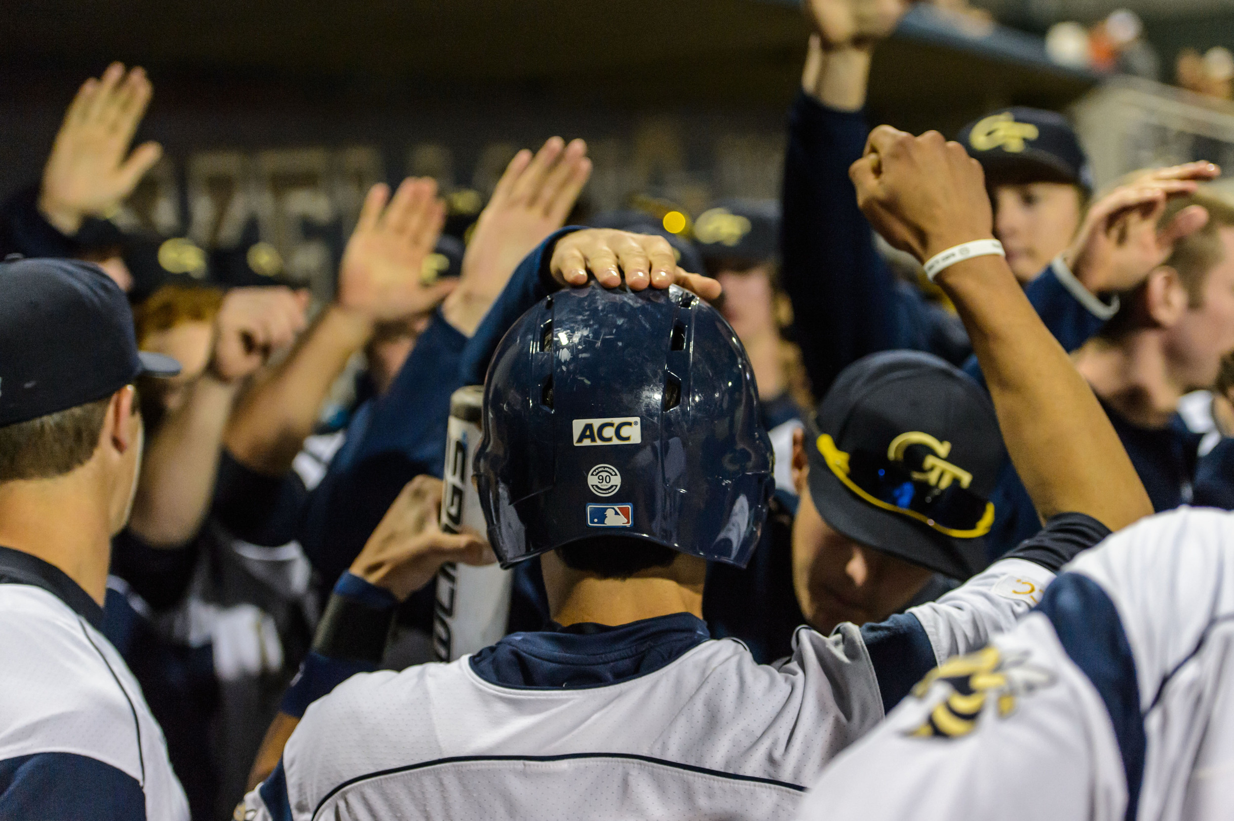 Elliott Barzilli (16) is congratulated by teammates after returning to the dugout.