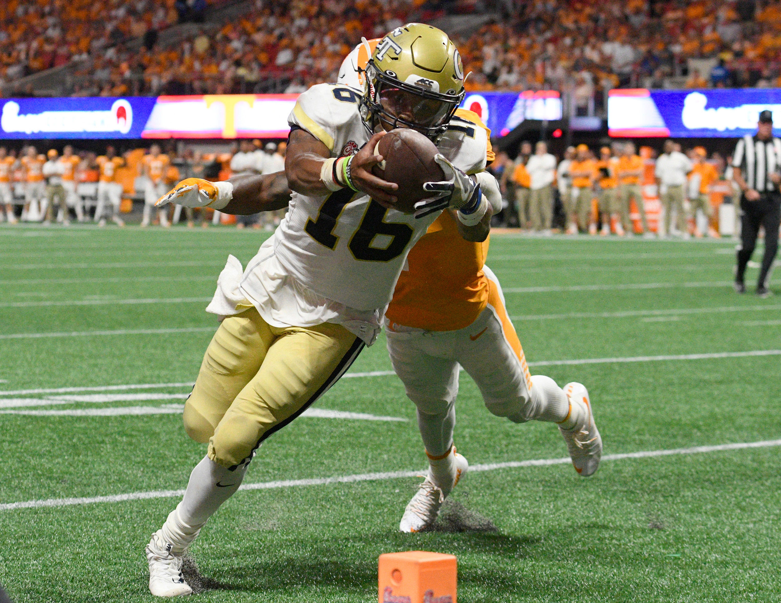 Sep 4, 2017; Atlanta, GA, USA; Georgia Tech Yellow Jackets quarterback TaQuon Marshall (16) scores a touchdown against Tennessee Volunteers defensive back Rashaan Gaulden (7) during the fourth quarter at Mercedes-Benz Stadium. Mandatory Credit: Dale Zanine-USA TODAY Sports