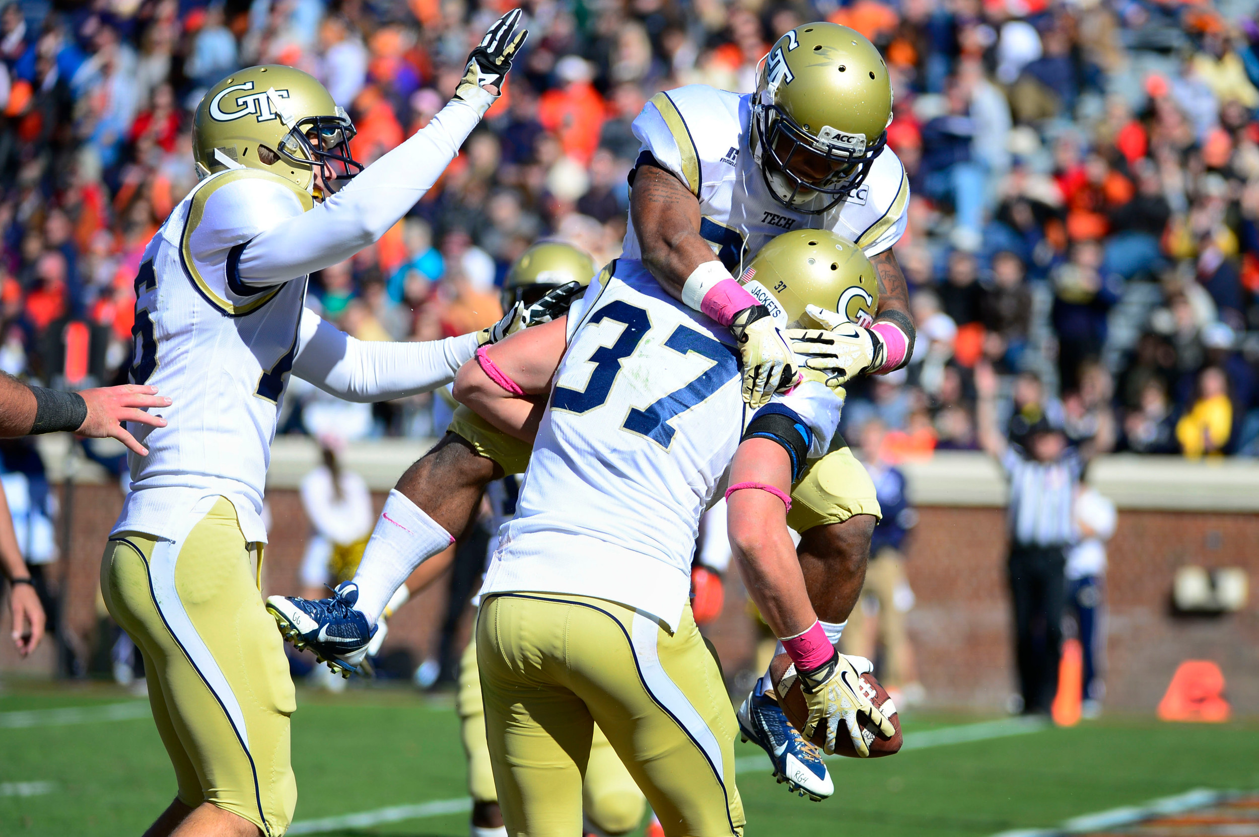 Zach Laskey (37) celebrates with wide receiver Corey Dennis (16) and running back Robert Godhigh (25) after scoring a touchdown. Mandatory Credit: Bob Donnan-USA TODAY Sports