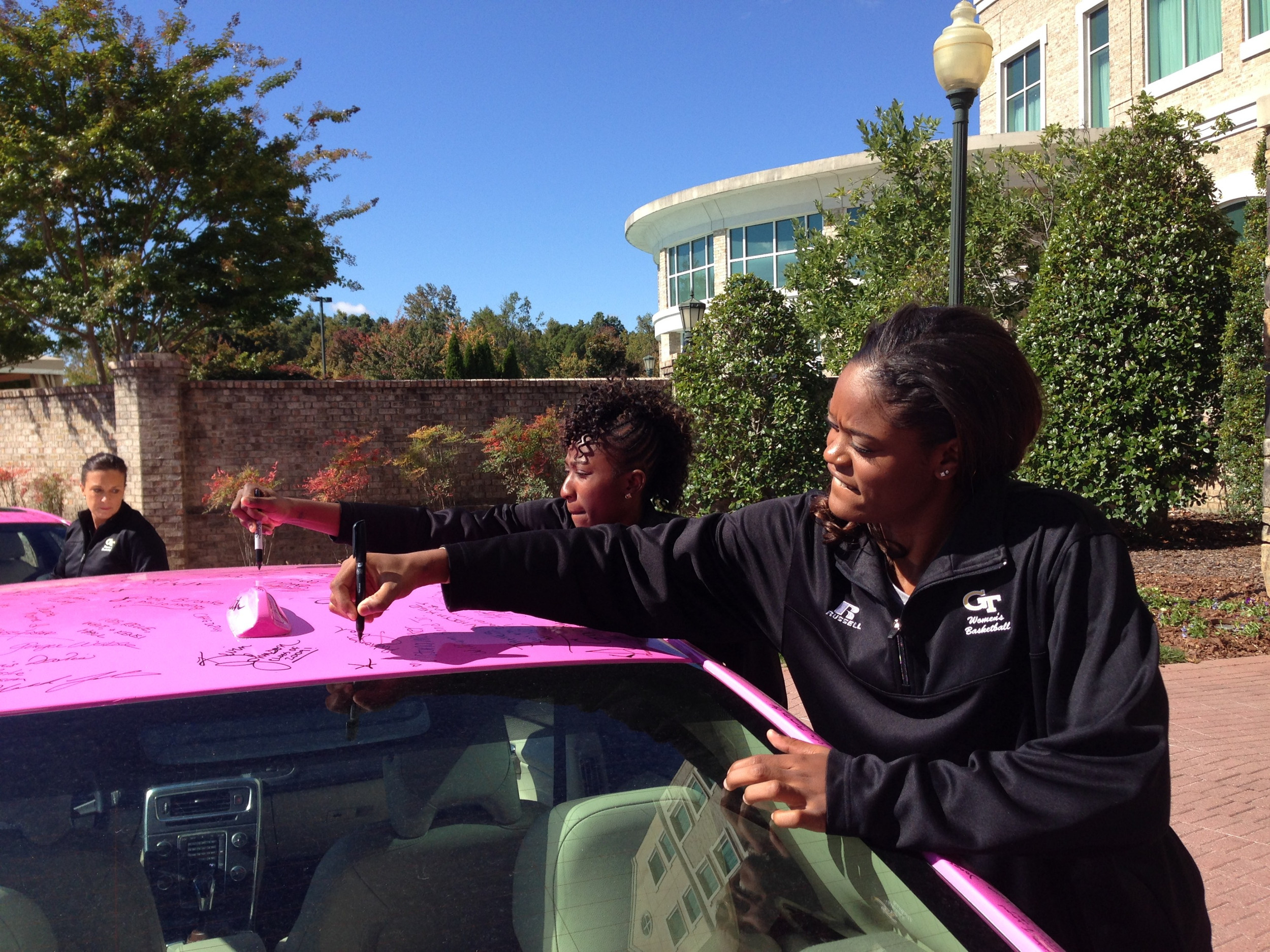 Sydney and Kaela sign the hope mobile.