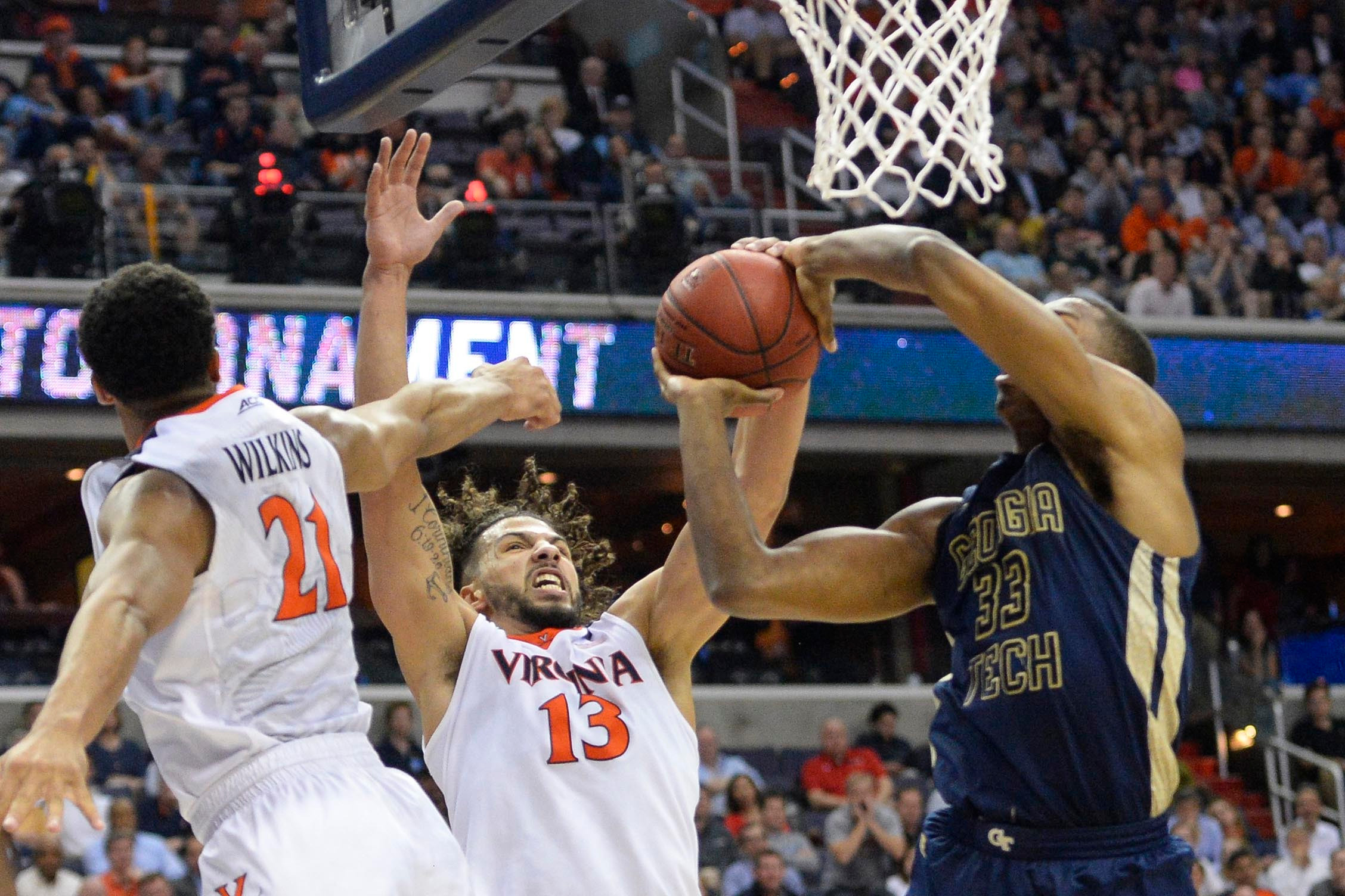 Mar 10, 2016; Washington, DC, USA; Virginia Cavaliers forward Anthony Gill (13) blocks a shot by Georgia Tech Yellow Jackets forward James White (33). Credit: Tommy Gilligan-USA TODAY Sports