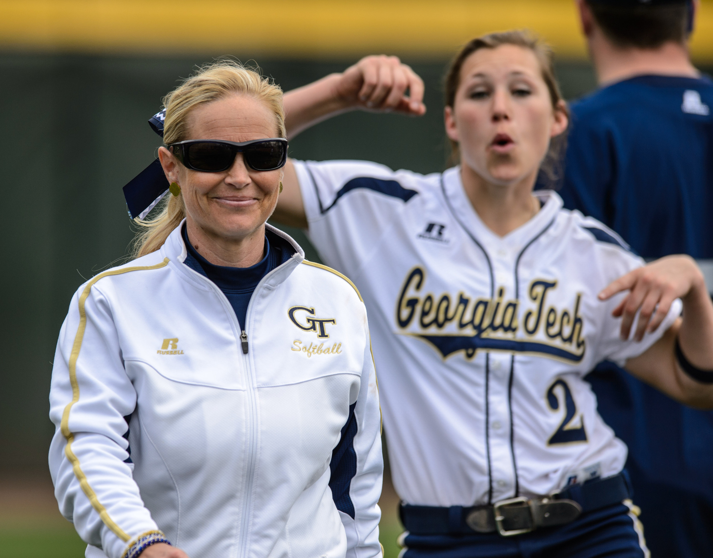 Head Coach Shelly Hoerner smiles after the win, while Maddie Lionberger (2) celebrates in the background.