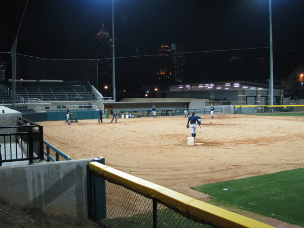 Softball team practices at night for the first time in its new stadium.