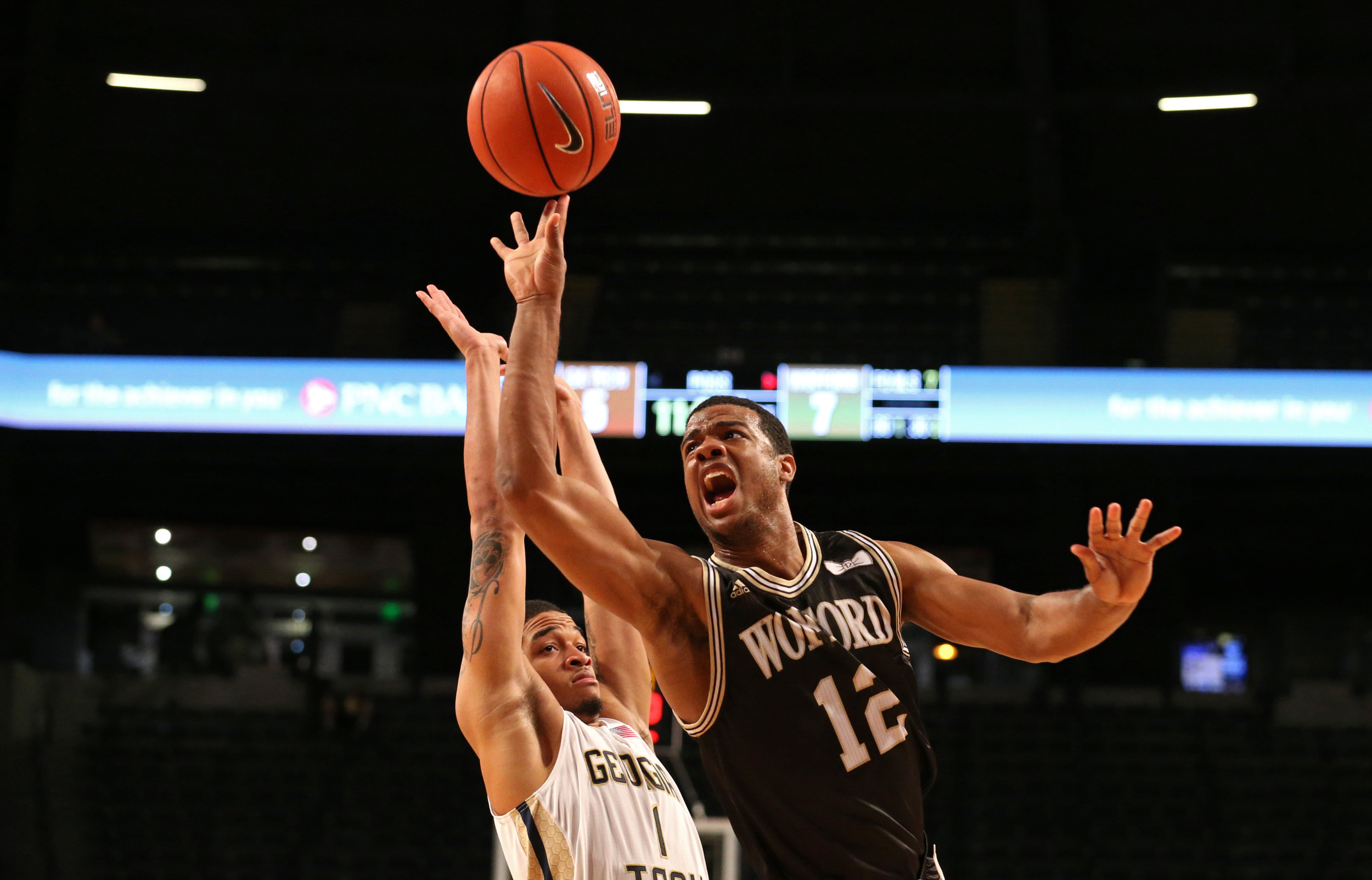 Dec 1, 2015; Atlanta, GA, USA; Wofford Terriers guard Spencer Collins (12) attempts a shot against Georgia Tech Yellow Jackets guard Tadric Jackson (1) in the first half of their game at McCamish Pavilion. Mandatory Credit: Jason Getz-USA TODAY Sports