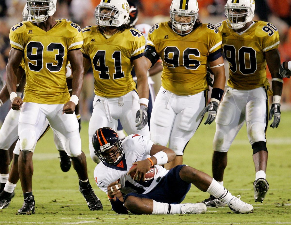 Georgia Tech defensive players including defensive end Michael Johnson (93), linebacker Philip Wheeler (41), tackle Joe Anoai (96) and end Darrell Robertson (90) stand over Virginia quarterback Jameel Sewell (10) after he was brought down by Georgia Tech linebacker KaMichael Hall. (AP Photo/Ric Feld)